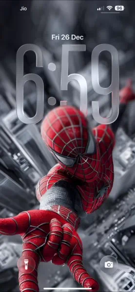 Download this awesome Spiderman 4K wallpaper for your iPhone, showcasing the iconic hero overlooking a grayscale cityscape. The wallpaper highlights Spiderman's red suit and webbed mask as he poses dramatically above the buildings.