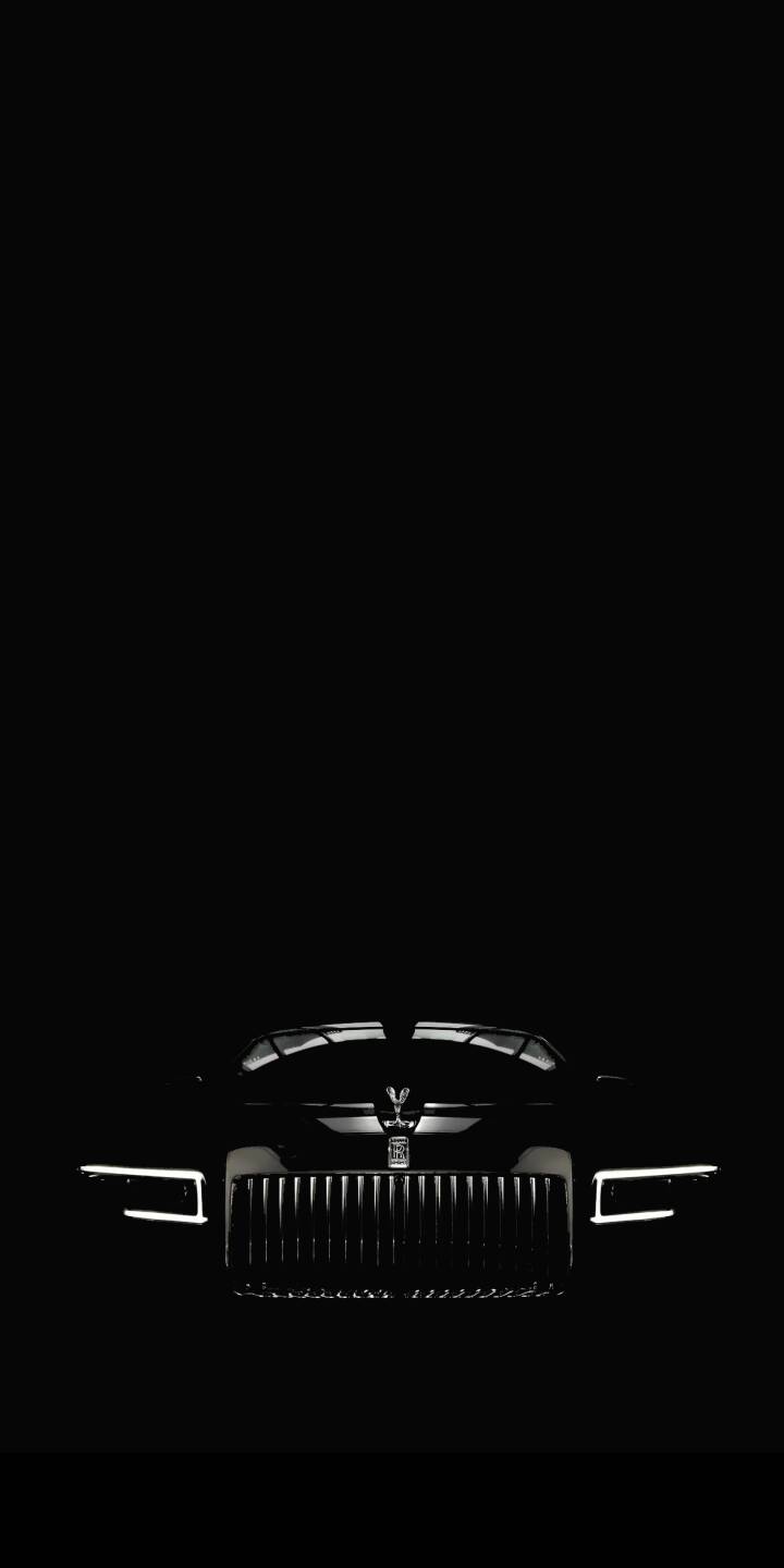 A stunningly minimalist Rolls-Royce Spectre wallpaper featuring the illuminated Pantheon grille. This AMOLED iPhone wallpaper provides a sleek, dark aesthetic for car enthusiasts. | grille minimalist luxury car 4k wallpaper automotive iphone wallpaper mobile wallpaper amoled wallpaper rolls-royce spectre A stunningly minimalist Rolls-Royce Spectre wallpaper featuring the illuminated Pantheon grille. This AMOLED iPhone wallpaper provides a sleek, dark aesthetic for car enthusiasts.