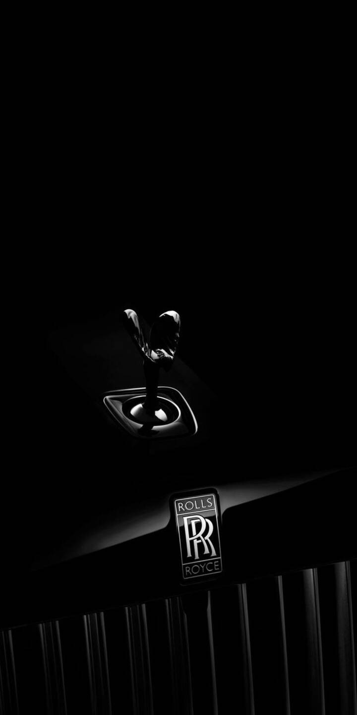 This premium Rolls-Royce wallpaper showcases the iconic Spirit of Ecstasy hood ornament in high contrast. A sophisticated dark iPhone wallpaper for a clean, luxury look. | emblem chrome luxury 4k wallpaper iphone wallpaper mobile wallpaper amoled wallpaper hood ornament spirit of ecstasy rolls-royce This premium Rolls-Royce wallpaper showcases the iconic Spirit of Ecstasy hood ornament in high contrast. A sophisticated dark iPhone wallpaper for a clean, luxury look.