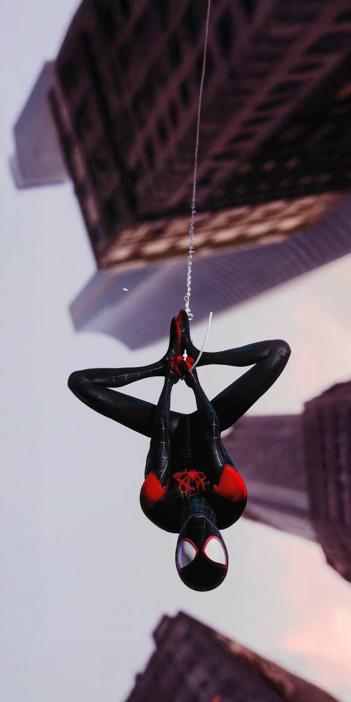 Download this awesome Miles Morales wallpaper in 4K for your iPhone, showcasing Spider-Man hanging upside down with a clear sky and looming buildings in the background. This unique wallpaper captures the essence of the character, with his sleek black suit and red accents. | superhero marvel iphone black suit miles morales mobile new york city 4k wallpaper hd wallpaper upside down red accents spider-man Download this awesome Miles Morales wallpaper in 4K for your iPhone, showcasing Spider-Man hanging upside down with a clear sky and looming buildings in the background. This unique wallpaper captures the essence of the character, with his sleek black suit and red accents.