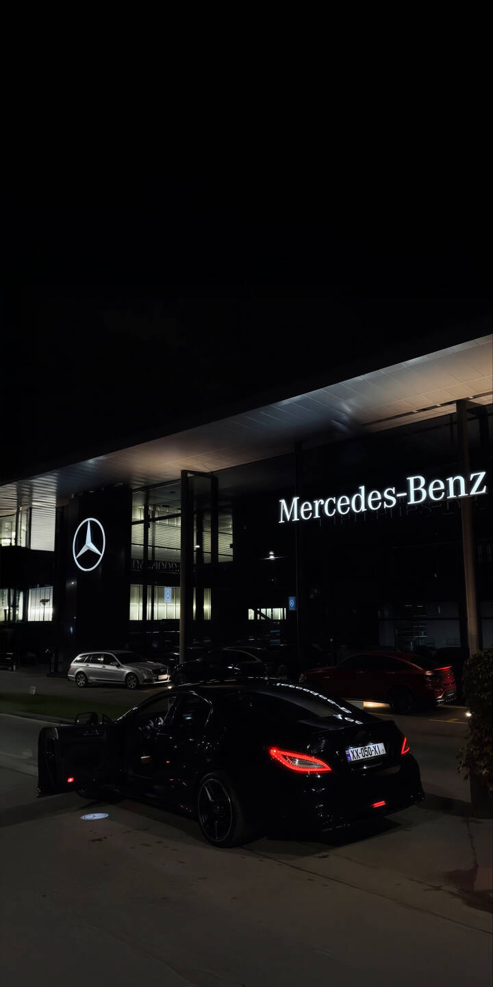Immerse yourself in the sleek, nighttime ambiance of this stunning 4K Mercedes-Benz AMG GT wallpaper, showcasing the iconic black car with its bright red taillights parked outside a brilliantly lit Mercedes-Benz dealership with its illuminated logo. This exquisite wallpaper is perfectly optimized for your iPhone, capturing the luxurious detail of the vehicle and its glowing surroundings. | car night iphone amg gt mobile luxury car mercedes-benz 4k wallpaper hd wallpaper dealership mercedes-benz amg gt Immerse yourself in the sleek, nighttime ambiance of this stunning 4K Mercedes-Benz AMG GT wallpaper, showcasing the iconic black car with its bright red taillights parked outside a brilliantly lit Mercedes-Benz dealership with its illuminated logo. This exquisite wallpaper is perfectly optimized for your iPhone, capturing the luxurious detail of the vehicle and its glowing surroundings.