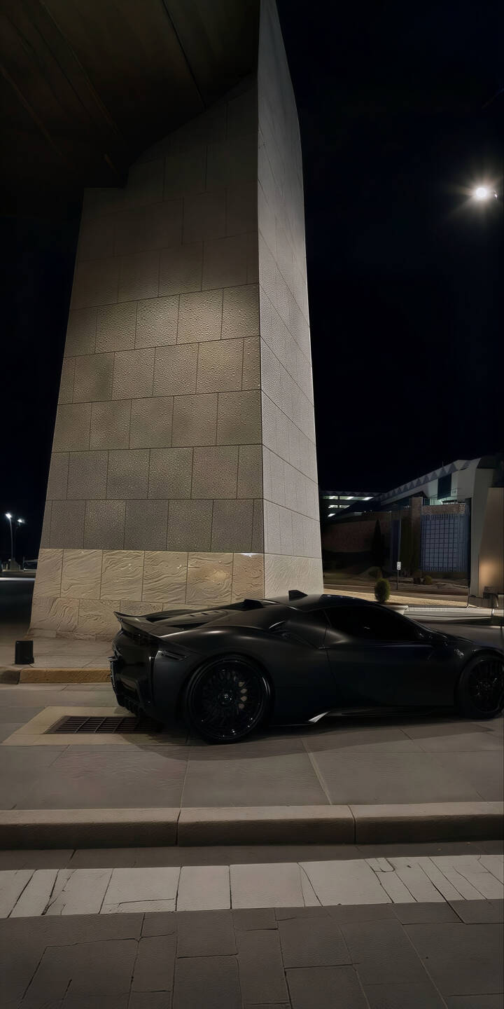 Elevate your iPhone screen with this stunning black sports car 4K wallpaper, featuring a sleek matte finish and an elegant rear spoiler against a dramatic nighttime backdrop. This premium wallpaper captures the car's bold silhouette and black wheels, perfect for a sophisticated mobile display. | iphone supercar mobile luxury car matte black 4k wallpaper hd wallpaper automotive car wallpaper dark aesthetic night car black sports car Elevate your iPhone screen with this stunning black sports car 4K wallpaper, featuring a sleek matte finish and an elegant rear spoiler against a dramatic nighttime backdrop. This premium wallpaper captures the car's bold silhouette and black wheels, perfect for a sophisticated mobile display.