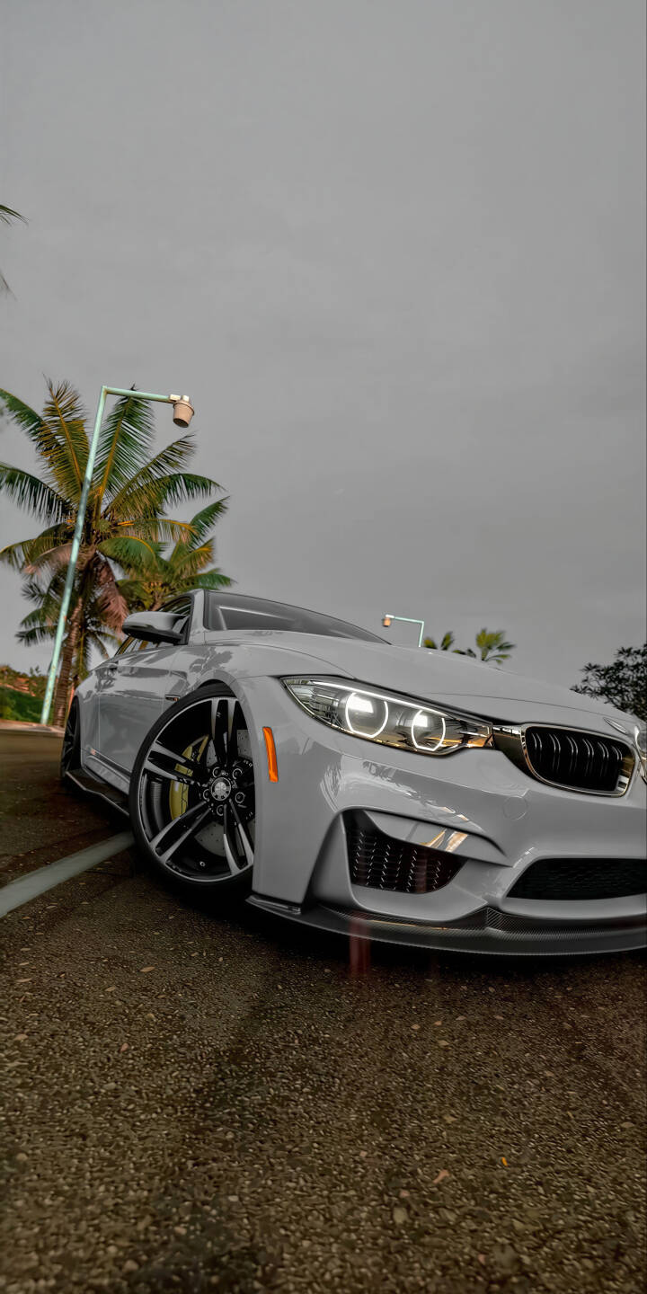 Elevate your screen with this stunning BMW M4 4K wallpaper, perfectly optimized for iPhone. This premium wallpaper captures the sleek white finish, iconic angel-eye headlights, and aggressive carbon fiber front lip of the M4, set against a tropical backdrop. | car sports car iphone bmw m4 bmw m4 mobile luxury car white car 4k wallpaper hd wallpaper automotive Elevate your screen with this stunning BMW M4 4K wallpaper, perfectly optimized for iPhone. This premium wallpaper captures the sleek white finish, iconic angel-eye headlights, and aggressive carbon fiber front lip of the M4, set against a tropical backdrop.