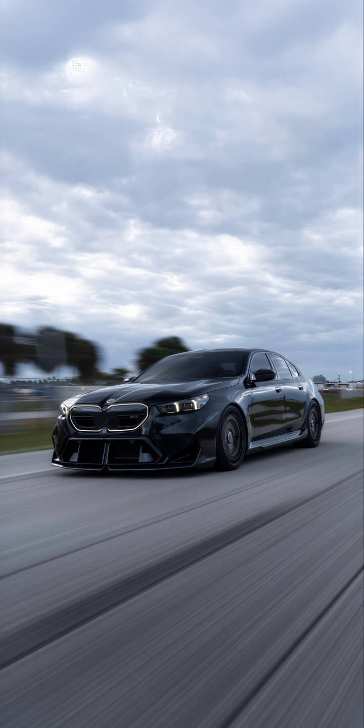 Elevate your device with this stunning black BMW M 4K wallpaper, featuring the sleek car with bright LED headlights and dynamic motion blur on the road under a cloudy sky. This high-resolution wallpaper is perfect for your iPhone, bringing speed and style to your screen. | car sports car iphone bmw black car mobile luxury car 4k wallpaper hd wallpaper automotive fast car bmw m Elevate your device with this stunning black BMW M 4K wallpaper, featuring the sleek car with bright LED headlights and dynamic motion blur on the road under a cloudy sky. This high-resolution wallpaper is perfect for your iPhone, bringing speed and style to your screen.