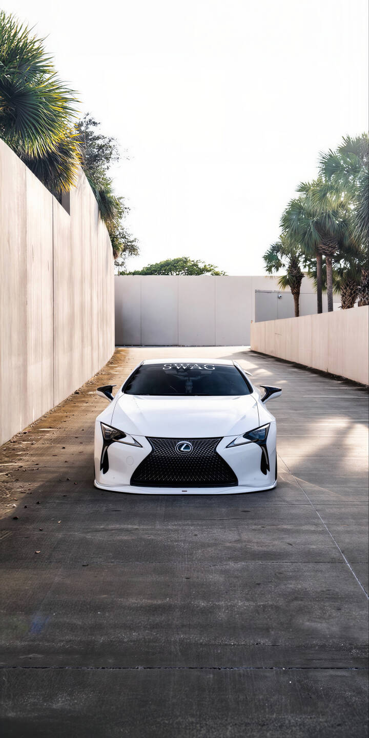 Elevate your iPhone screen with this stunning 4K Lexus LC 500 wallpaper, showcasing the pristine white car with its aggressive black grille and ultra-sleek design on a sun-drenched concrete pathway. This premium wallpaper captures the luxury sport coupe's elegance against a minimalist backdrop, perfect for car enthusiasts. | iphone mobile luxury car lexus white car 4k wallpaper hd wallpaper automobile sport car lexus lc 500 lc500 Elevate your iPhone screen with this stunning 4K Lexus LC 500 wallpaper, showcasing the pristine white car with its aggressive black grille and ultra-sleek design on a sun-drenched concrete pathway. This premium wallpaper captures the luxury sport coupe's elegance against a minimalist backdrop, perfect for car enthusiasts.