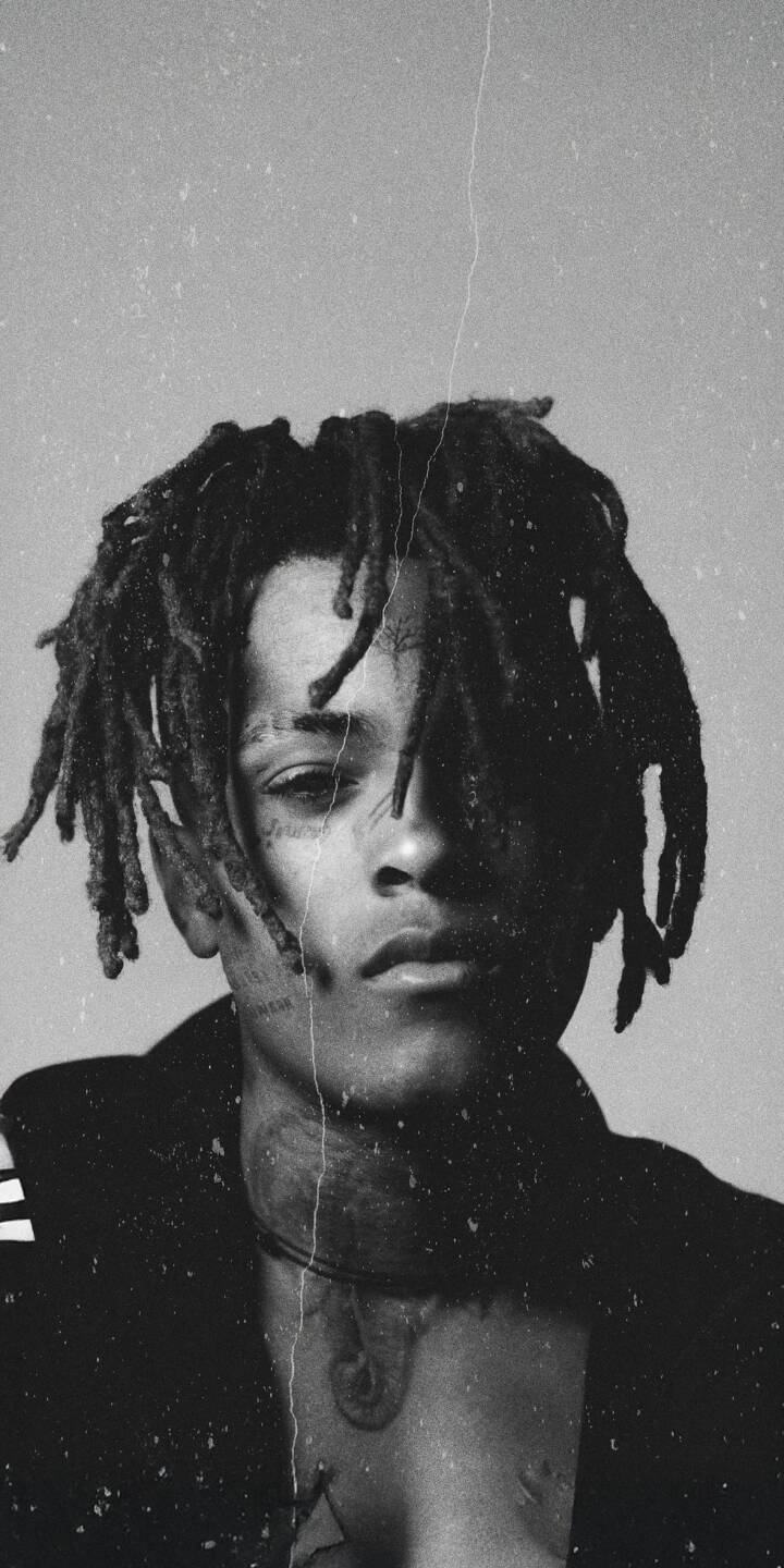 Elevate your iPhone with this striking XXXTentacion 4K wallpaper, featuring the artist in a raw black and white aesthetic with distressed textures. This high-resolution wallpaper perfectly captures his iconic dreadlocks and visible neck tattoos, making it an essential addition for fans. | rap rapper portrait xxxtentacion iphone black and white x hip hop mobile 4k wallpaper hd wallpaper Elevate your iPhone with this striking XXXTentacion 4K wallpaper, featuring the artist in a raw black and white aesthetic with distressed textures. This high-resolution wallpaper perfectly captures his iconic dreadlocks and visible neck tattoos, making it an essential addition for fans.