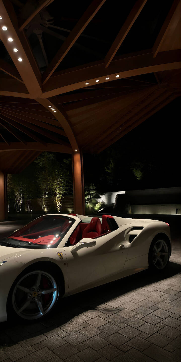 Elevate your screen with this magnificent 4K wallpaper showcasing a pristine white Ferrari convertible, boasting a vibrant red interior, parked under an elegant wooden canopy with warm spotlights at night, perfectly optimized for your iPhone. This premium car wallpaper is designed to bring a touch of luxury to your mobile device. | sports car iphone ferrari mobile luxury car 4k wallpaper hd wallpaper automotive white ferrari red interior night car ferrari convertible Elevate your screen with this magnificent 4K wallpaper showcasing a pristine white Ferrari convertible, boasting a vibrant red interior, parked under an elegant wooden canopy with warm spotlights at night, perfectly optimized for your iPhone. This premium car wallpaper is designed to bring a touch of luxury to your mobile device.