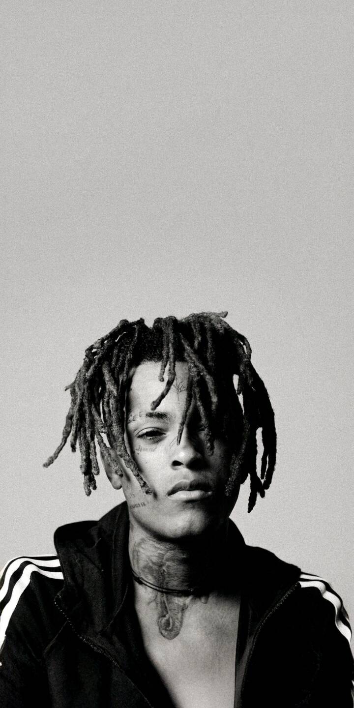Download this striking XXXTentacion 4K wallpaper, perfect for your iPhone. This high-definition wallpaper features the artist in a captivating black and white portrait, showcasing his iconic dreadlocks and intricate neck tattoo. | aesthetic rapper music portrait xxxtentacion iphone black and white mobile 4k wallpaper hd wallpaper dreadlocks jahseh onfroy Download this striking XXXTentacion 4K wallpaper, perfect for your iPhone. This high-definition wallpaper features the artist in a captivating black and white portrait, showcasing his iconic dreadlocks and intricate neck tattoo.