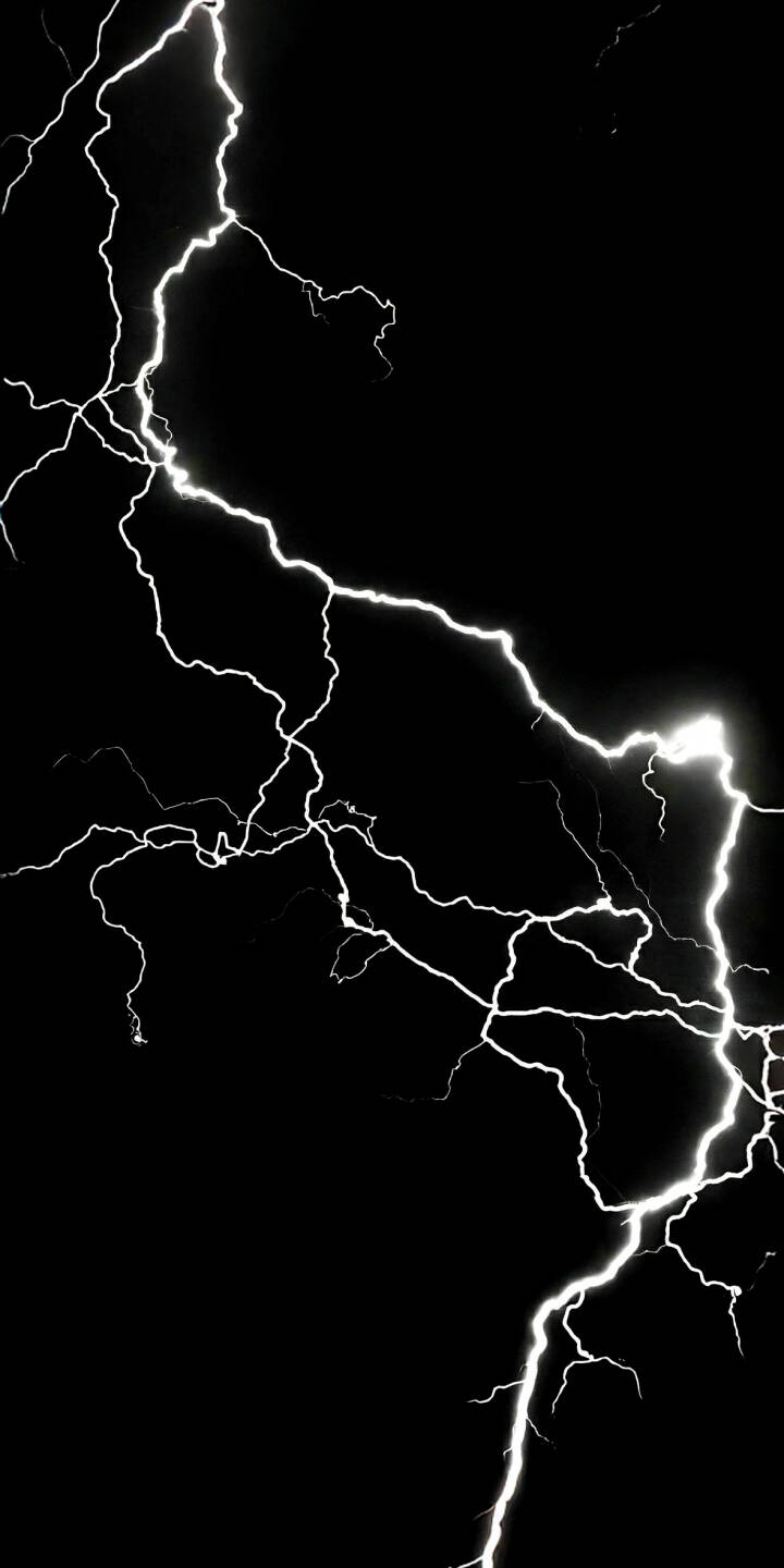 This captivating lightning wallpaper, rendered in stunning 4K, showcases a dramatic white electrical discharge against a deep black background, making it an ideal wallpaper for your iPhone. The intricate, jagged lines of the lightning bolt illuminate the darkness with their brilliant white glow, creating a striking and minimalist aesthetic. | lightning dark storm iphone nature minimalist black background mobile 4k wallpaper hd wallpaper thunderbolt electricity This captivating lightning wallpaper, rendered in stunning 4K, showcases a dramatic white electrical discharge against a deep black background, making it an ideal wallpaper for your iPhone. The intricate, jagged lines of the lightning bolt illuminate the darkness with their brilliant white glow, creating a striking and minimalist aesthetic.