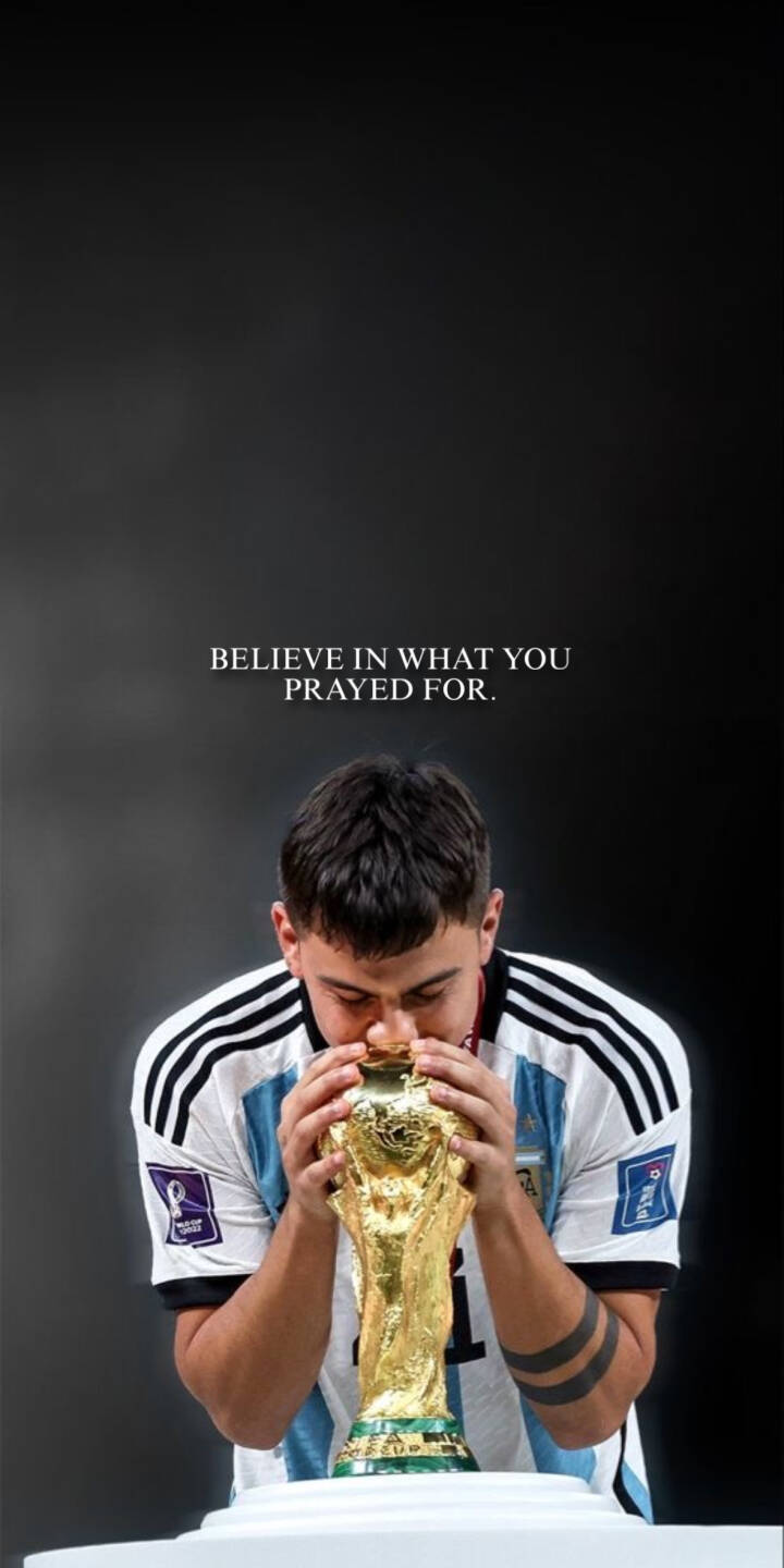 Elevate your iPhone screen with this stunning 4K wallpaper featuring Paulo Dybala passionately kissing the gleaming World Cup trophy, adorned in his iconic Argentina jersey. This inspirational wallpaper, complete with the powerful quote 'BELIEVE IN WHAT YOU PRAYED FOR.', is perfect for any football fan. | football trophy iphone argentina soccer champion mobile 4k wallpaper hd wallpaper world cup paulo dybala dybala Elevate your iPhone screen with this stunning 4K wallpaper featuring Paulo Dybala passionately kissing the gleaming World Cup trophy, adorned in his iconic Argentina jersey. This inspirational wallpaper, complete with the powerful quote 'BELIEVE IN WHAT YOU PRAYED FOR.', is perfect for any football fan.