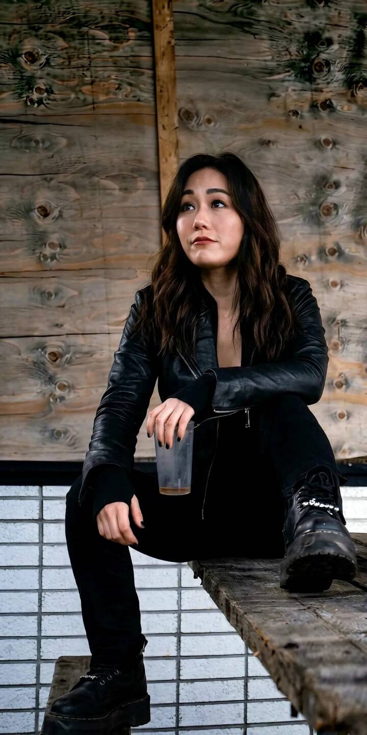 A pensive young woman in a chic black leather jacket gazes thoughtfully against a rustic wooden wall, making a stylish 4K wallpaper for your iPhone. This captivating dark aesthetic is perfect for an edgy mobile wallpaper. | aesthetic girl woman portrait leather jacket iphone lady wallpaper asian mobile 4k wallpaper hd wallpaper A pensive young woman in a chic black leather jacket gazes thoughtfully against a rustic wooden wall, making a stylish 4K wallpaper for your iPhone. This captivating dark aesthetic is perfect for an edgy mobile wallpaper.
