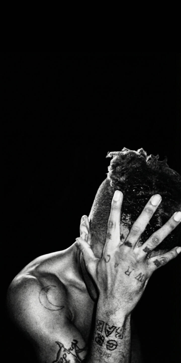 Emotive and raw, XXXTentacion's hand covers his face in this powerful black and white 4K wallpaper, highlighting his distinctive tattoos. This deeply artistic wallpaper is perfect for personalizing your iPhone. | rapper dark xxxtentacion iphone wallpaper hip hop mobile moody 4k wallpaper hd wallpaper monochrome jahseh onfroy Emotive and raw, XXXTentacion's hand covers his face in this powerful black and white 4K wallpaper, highlighting his distinctive tattoos. This deeply artistic wallpaper is perfect for personalizing your iPhone.