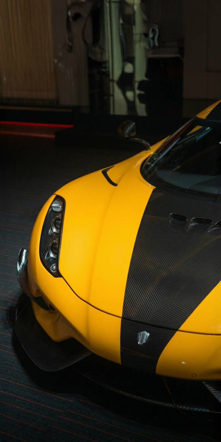 The vibrant yellow finish of the Koenigsegg Jesko gleams alongside its sharp black carbon fiber details and distinctive headlights in this striking 4K wallpaper. Perfect for automotive enthusiasts, this high-performance hypercar wallpaper is an ideal choice for your iPhone screen. | iphone wallpaper hypercar koenigsegg mobile jesko yellow car carbon fiber 4k wallpaper hd wallpaper automotive The vibrant yellow finish of the Koenigsegg Jesko gleams alongside its sharp black carbon fiber details and distinctive headlights in this striking 4K wallpaper. Perfect for automotive enthusiasts, this high-performance hypercar wallpaper is an ideal choice for your iPhone screen.