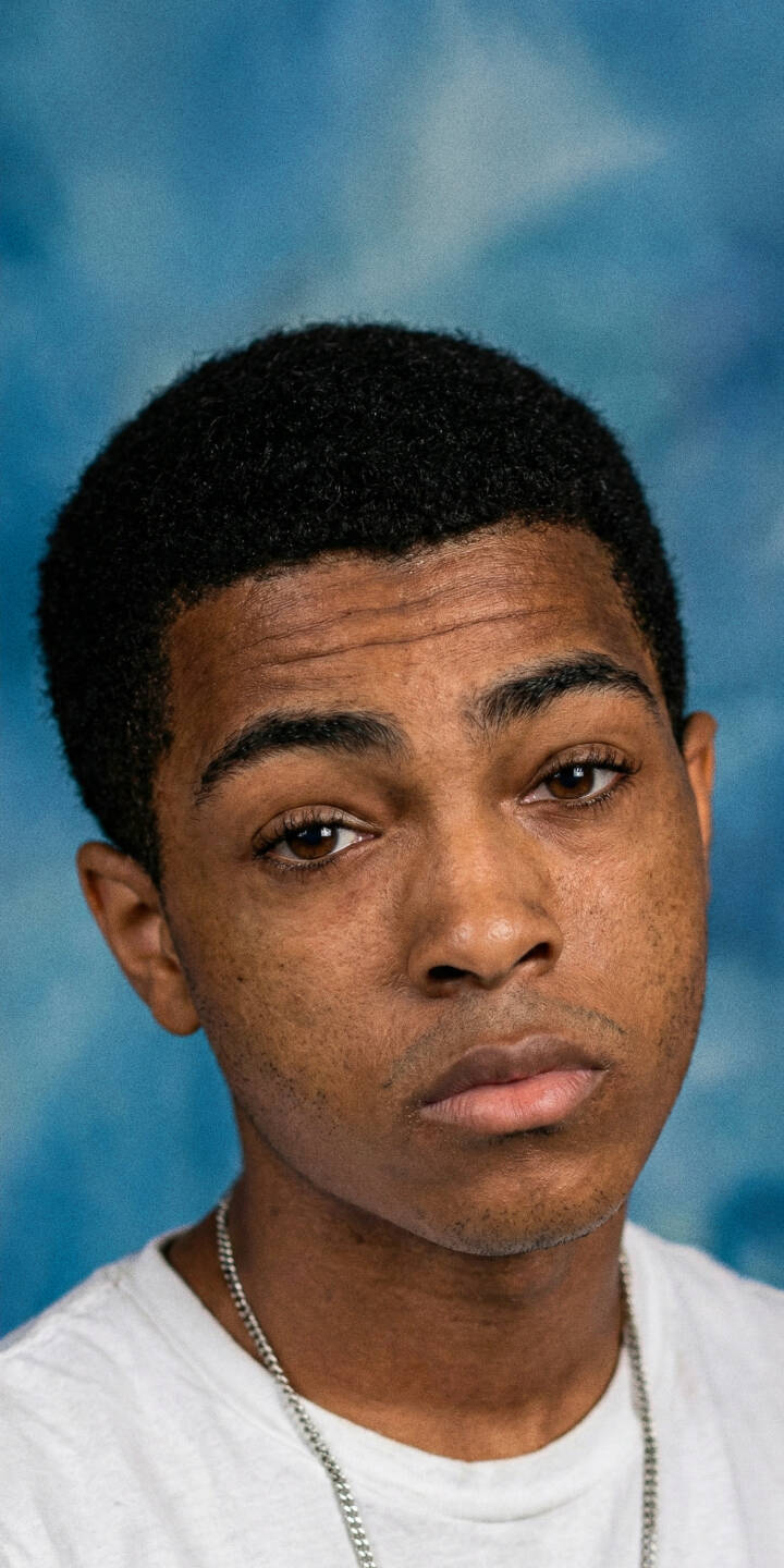 XXXTENTACION's contemplative expression shines against a textured blue backdrop in this clear 4K wallpaper, an essential mobile wallpaper for any iPhone user and fan. | rapper music portrait xxxtentacion iphone wallpaper hip hop mobile 4k wallpaper hd wallpaper blue background jahseh onfroy XXXTENTACION's contemplative expression shines against a textured blue backdrop in this clear 4K wallpaper, an essential mobile wallpaper for any iPhone user and fan.