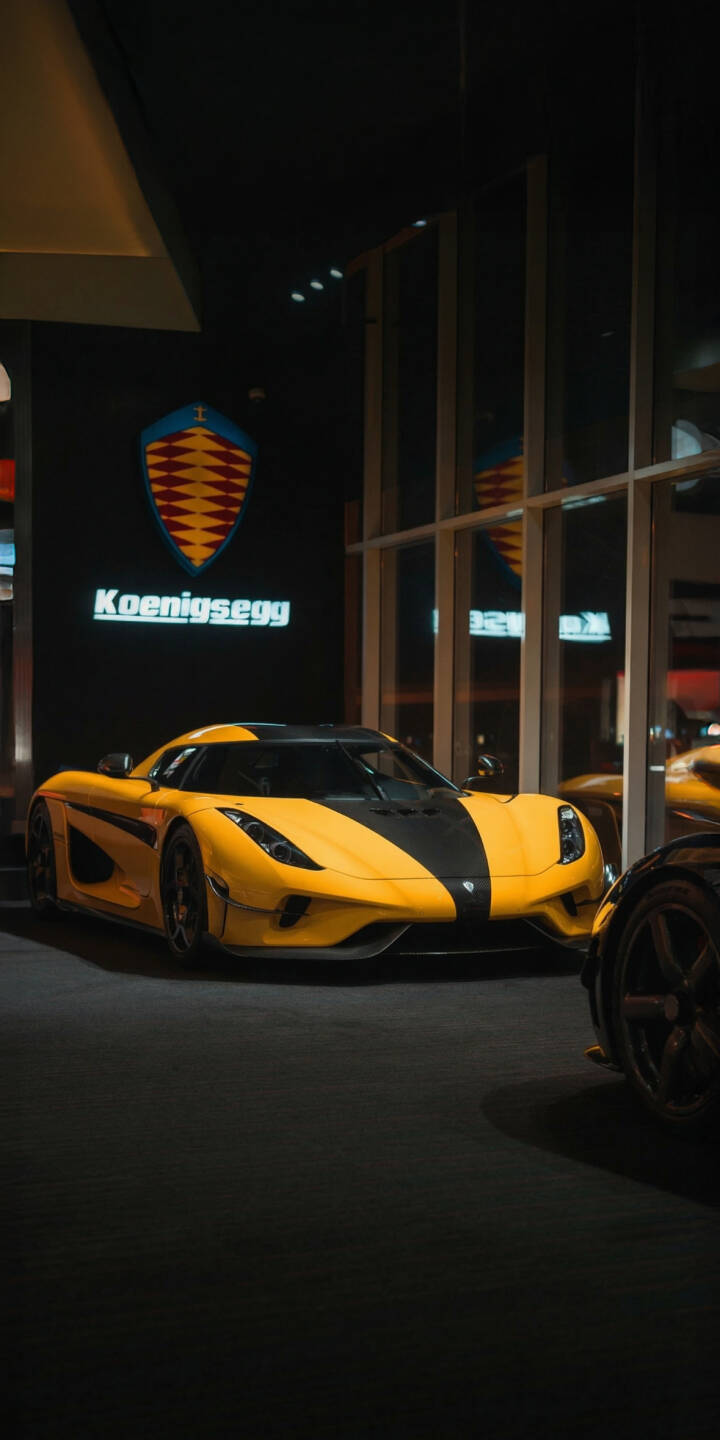 The stunning yellow and black Koenigsegg Regera gleams under the showroom lights, perfectly framed by reflective glass, creating an elite 4K wallpaper. This exquisite automotive wallpaper is a must-have for any iPhone showcasing a passion for hypercars. | iphone supercar wallpaper hypercar koenigsegg mobile luxury car yellow car 4k wallpaper hd wallpaper automotive koenigsegg regera The stunning yellow and black Koenigsegg Regera gleams under the showroom lights, perfectly framed by reflective glass, creating an elite 4K wallpaper. This exquisite automotive wallpaper is a must-have for any iPhone showcasing a passion for hypercars.
