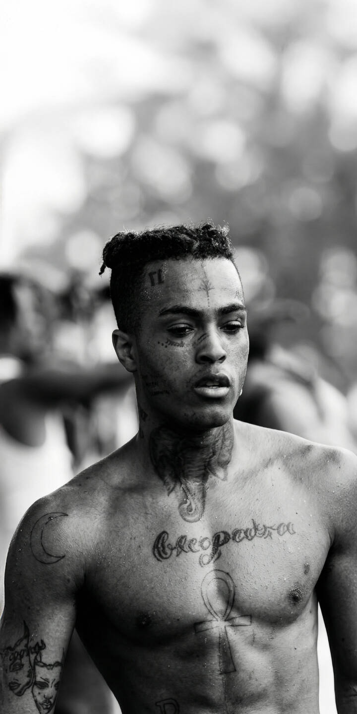 XXXTentacion's distinctive facial and chest tattoos, including "Cleopatra" and an Ankh, are sharply detailed in this compelling 4K wallpaper. This powerful black and white XXXTentacion wallpaper is perfect for personalizing your iPhone. | rapper music xxxtentacion iphone wallpaper black and white hip hop mobile 4k wallpaper hd wallpaper tattoos jahseh onfroy XXXTentacion's distinctive facial and chest tattoos, including "Cleopatra" and an Ankh, are sharply detailed in this compelling 4K wallpaper. This powerful black and white XXXTentacion wallpaper is perfect for personalizing your iPhone.