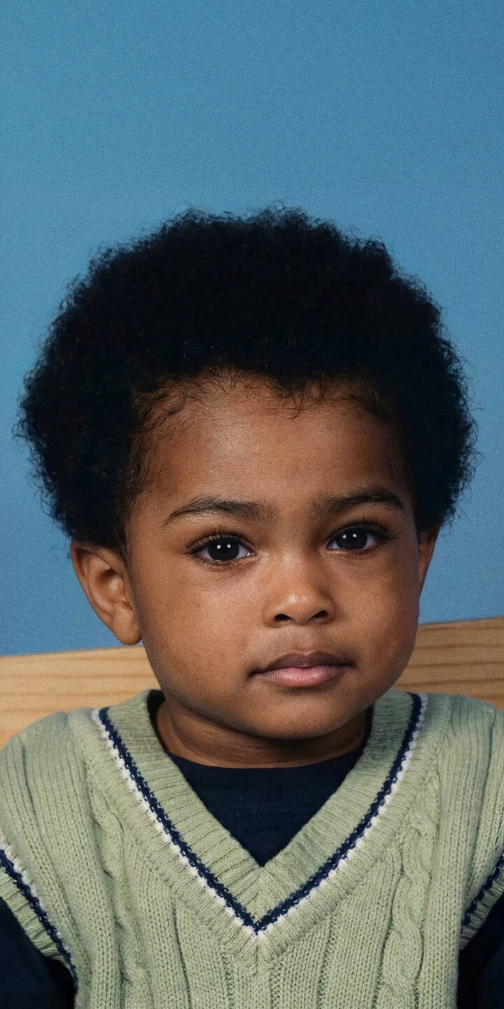 Those wide, innocent dark eyes of young Jahseh Onfroy gaze thoughtfully from this endearing 4K wallpaper, set against a calm blue backdrop. This high-resolution wallpaper, showcasing his distinctive fluffy hair and cozy green knit vest, makes a charming iPhone wallpaper for fans. | aesthetic portrait cute xxxtentacion iphone wallpaper mobile 4k wallpaper hd wallpaper childhood jahseh onfroy young xxxtentacion Those wide, innocent dark eyes of young Jahseh Onfroy gaze thoughtfully from this endearing 4K wallpaper, set against a calm blue backdrop. This high-resolution wallpaper, showcasing his distinctive fluffy hair and cozy green knit vest, makes a charming iPhone wallpaper for fans.