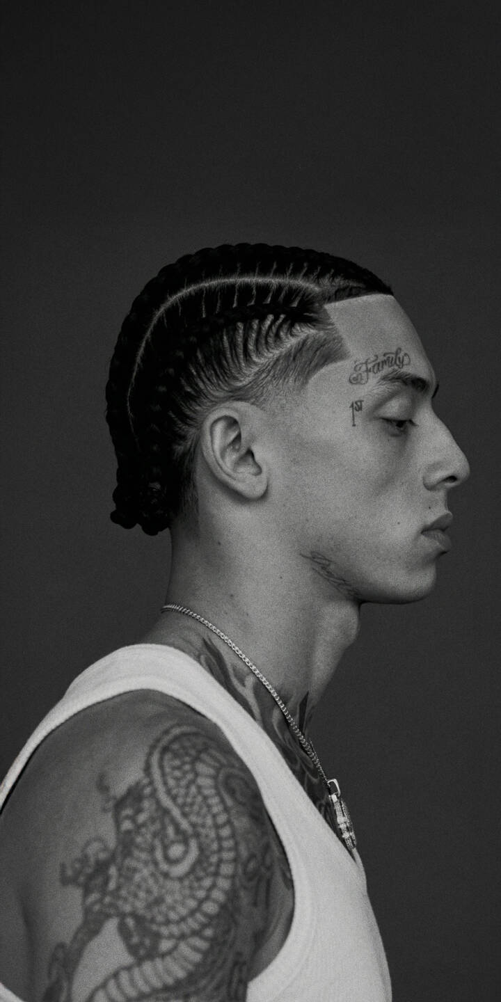 The crisp detail of the man's intricate cornrow braids and sharp fade are central in this striking 4K profile wallpaper. Featuring distinct 'Family' and '1st' face tattoos alongside a prominent shoulder tattoo, this powerful monochromatic wallpaper is ideal for iPhone users. | man portrait profile iphone wallpaper mobile cornrows 4k wallpaper hd wallpaper braids monochrome tattoos The crisp detail of the man's intricate cornrow braids and sharp fade are central in this striking 4K profile wallpaper. Featuring distinct 'Family' and '1st' face tattoos alongside a prominent shoulder tattoo, this powerful monochromatic wallpaper is ideal for iPhone users.