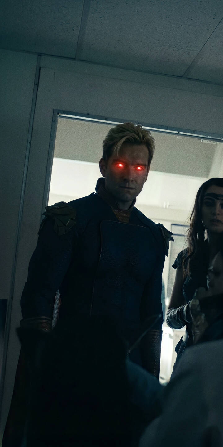 Homelander's eyes burn with an eerie red glow, signaling an intense and menacing presence in this striking 4K wallpaper — a powerful wallpaper for iPhone users who admire 'The Boys'. | the boys homelander iphone wallpaper red eyes mobile 4k wallpaper hd wallpaper dark aesthetic menacing laser eyes supervillain Homelander's eyes burn with an eerie red glow, signaling an intense and menacing presence in this striking 4K wallpaper — a powerful wallpaper for iPhone users who admire 'The Boys'.