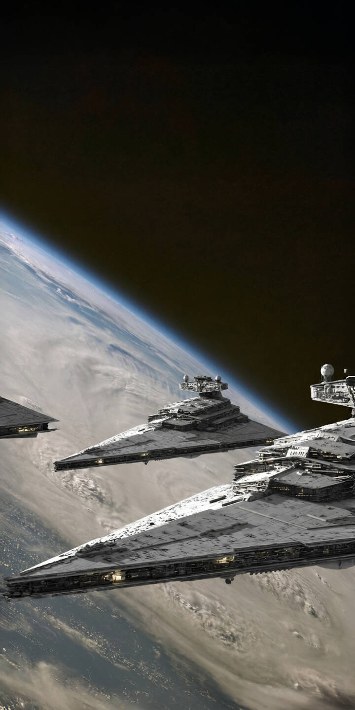 The colossal gray hulls of Imperial Star Destroyers dominate the void, menacingly orbiting a cloud-swirled planet in this stunning 4K wallpaper — a must-have Star Wars wallpaper for iPhone fans. | space spacecraft iphone wallpaper mobile 4k wallpaper hd wallpaper epic sci-fi star wars star destroyer imperial fleet The colossal gray hulls of Imperial Star Destroyers dominate the void, menacingly orbiting a cloud-swirled planet in this stunning 4K wallpaper — a must-have Star Wars wallpaper for iPhone fans.