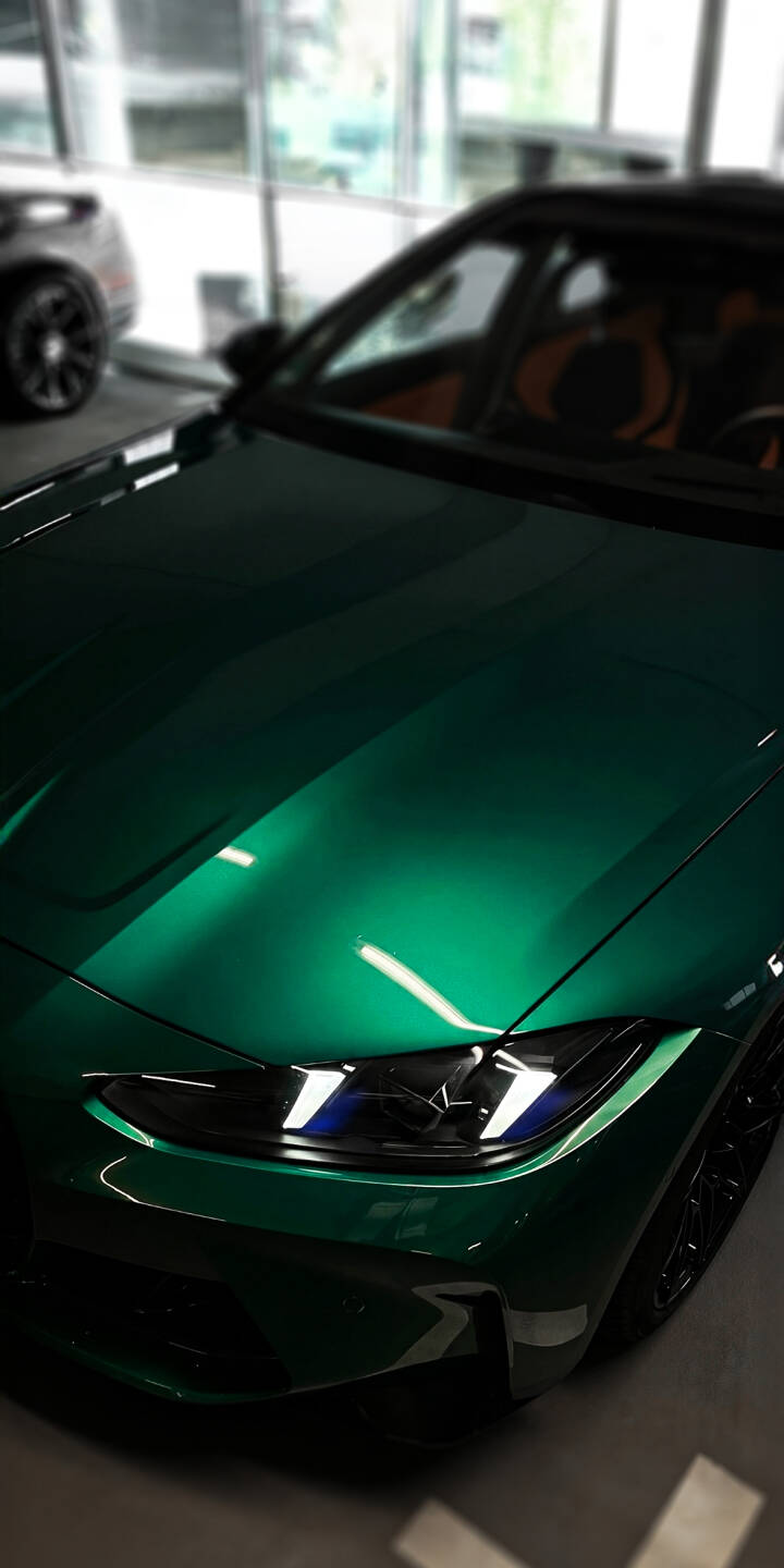 The stunning emerald green metallic paint gleams under showroom lights on this powerful BMW M4, making it a vibrant 4K wallpaper. This dynamic car wallpaper, highlighting its sleek headlights and rich color, is perfect for your iPhone screen. | car sports car iphone bmw wallpaper bmw m4 mobile green car 4k wallpaper hd wallpaper automotive sleek The stunning emerald green metallic paint gleams under showroom lights on this powerful BMW M4, making it a vibrant 4K wallpaper. This dynamic car wallpaper, highlighting its sleek headlights and rich color, is perfect for your iPhone screen.