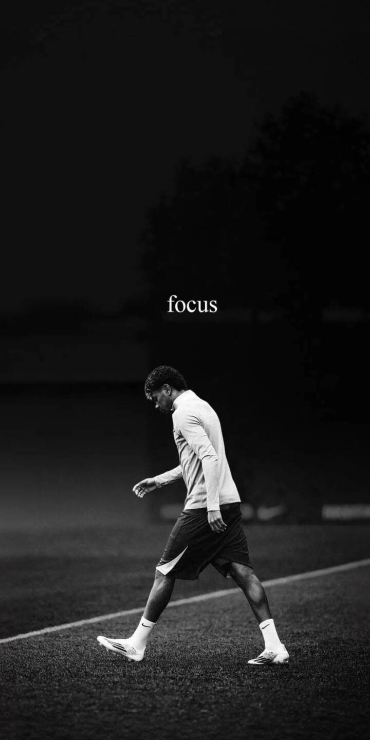 The stark black and white aesthetic combined with the bold "focus" text defines this powerful 4K wallpaper, featuring a determined football player walking on the field with intent; it's a motivational wallpaper for iPhone users seeking inspiration. | football player athlete motivation focus iphone soccer wallpaper mobile 4k wallpaper hd wallpaper monochrome The stark black and white aesthetic combined with the bold "focus" text defines this powerful 4K wallpaper, featuring a determined football player walking on the field with intent; it's a motivational wallpaper for iPhone users seeking inspiration.