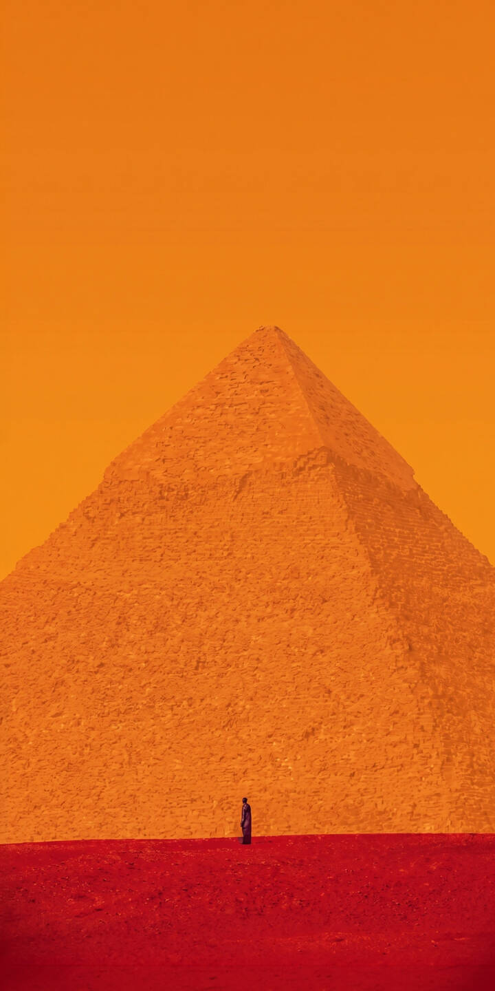 The colossal orange pyramid dominates this striking 4K wallpaper, towering over a tiny solitary figure standing on vibrant red sands. This unique minimalist desert landscape wallpaper, with its bold color palette, is a must-have for iPhone users. | landscape orange red desert iphone minimalist wallpaper mobile pyramid solitude 4k wallpaper hd wallpaper The colossal orange pyramid dominates this striking 4K wallpaper, towering over a tiny solitary figure standing on vibrant red sands. This unique minimalist desert landscape wallpaper, with its bold color palette, is a must-have for iPhone users.