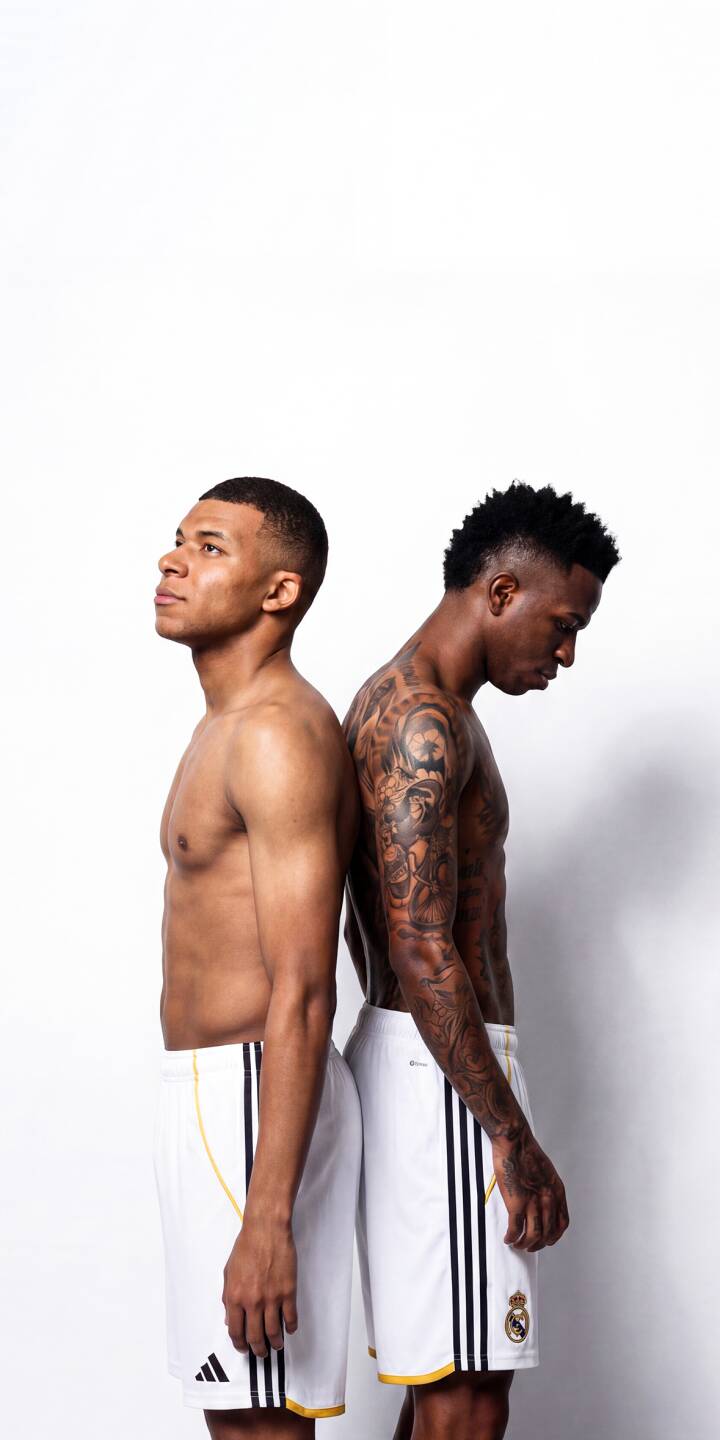 Kylian Mbappé and Vinicius Jr. strike an athletic back-to-back pose, shirtless and displaying Vinicius's intricate arm tattoos, in this stunning 4K wallpaper. This dynamic duo provides a powerful iPhone wallpaper for any soccer enthusiast. | sports football duo athlete iphone soccer wallpaper vinicius jr mobile 4k wallpaper hd wallpaper kylian mbappe Kylian Mbappé and Vinicius Jr. strike an athletic back-to-back pose, shirtless and displaying Vinicius's intricate arm tattoos, in this stunning 4K wallpaper. This dynamic duo provides a powerful iPhone wallpaper for any soccer enthusiast.
