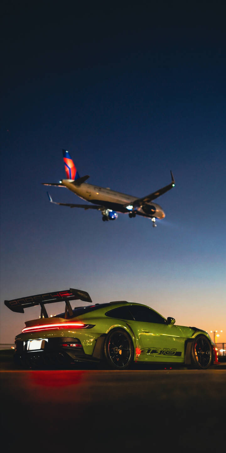 The vibrant lime green Porsche GT3 RS gleams under a dark twilight sky, with its red tail lights reflecting below, creating a stunning 4K wallpaper that features a plane descending overhead. This dynamic scene makes for an exciting iPhone wallpaper. | sports car twilight iphone porsche airplane wallpaper mobile gt3 rs 4k wallpaper hd wallpaper automotive lime green The vibrant lime green Porsche GT3 RS gleams under a dark twilight sky, with its red tail lights reflecting below, creating a stunning 4K wallpaper that features a plane descending overhead. This dynamic scene makes for an exciting iPhone wallpaper.