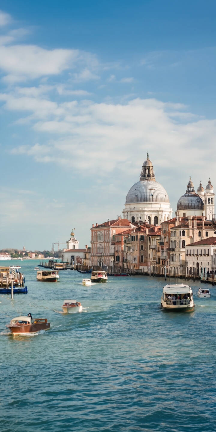 Sunlit water taxis cruise the turquoise Grand Canal beneath the majestic dome of Santa Maria della Salute in this stunning 4K Venice wallpaper. This iconic cityscape provides a serene wallpaper for iPhone, perfect for travel enthusiasts. | travel iphone wallpaper mobile italy venice 4k wallpaper hd wallpaper cityscape scenic grand canal boats Sunlit water taxis cruise the turquoise Grand Canal beneath the majestic dome of Santa Maria della Salute in this stunning 4K Venice wallpaper. This iconic cityscape provides a serene wallpaper for iPhone, perfect for travel enthusiasts.