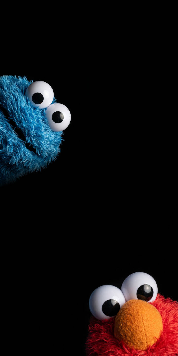 Large, white googly eyes belonging to Cookie Monster and Elmo peek playfully from the corners of this minimalist 4K wallpaper. This charming wallpaper is perfect for personalizing your iPhone screen. | cute iphone minimalist wallpaper mobile sesame street elmo cookie monster 4k wallpaper hd wallpaper googly eyes puppets Large, white googly eyes belonging to Cookie Monster and Elmo peek playfully from the corners of this minimalist 4K wallpaper. This charming wallpaper is perfect for personalizing your iPhone screen.