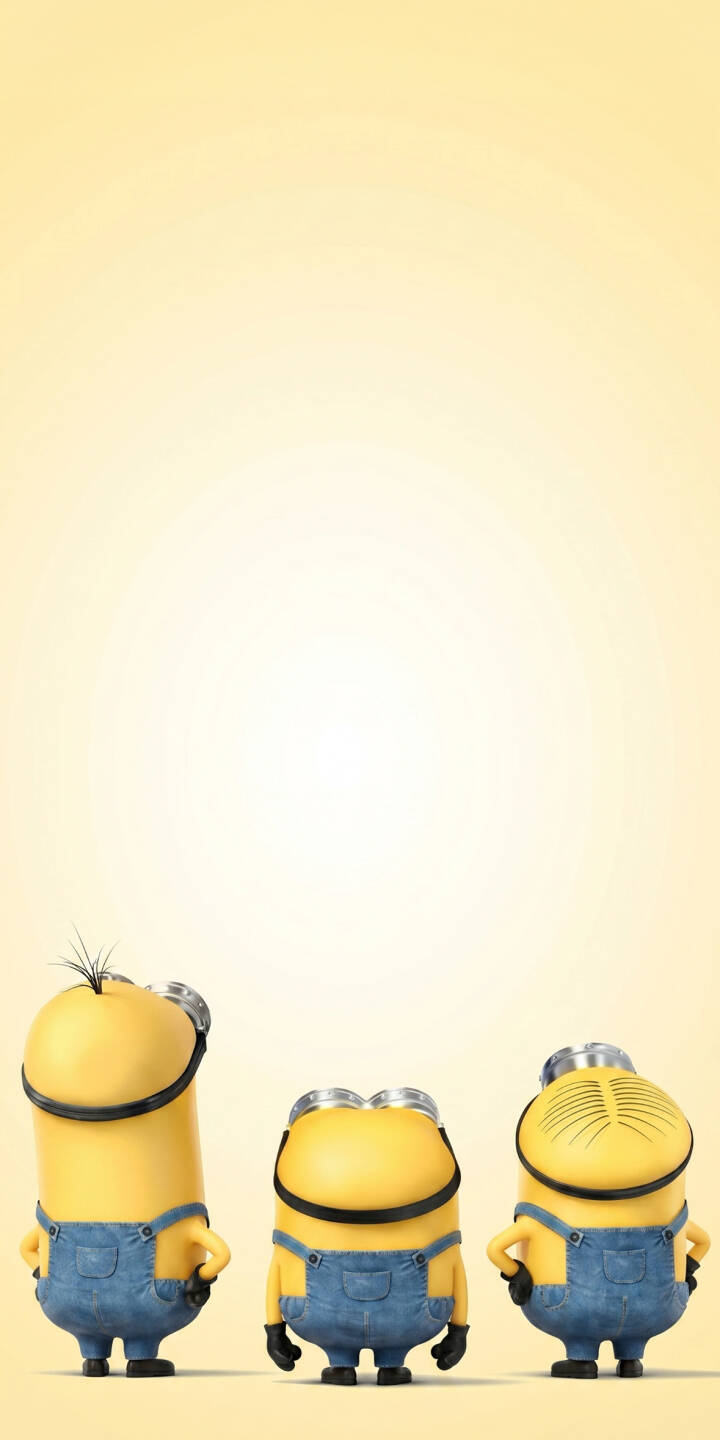 Three iconic Minions, each with their unique hairstyle and signature blue overalls, stand cheerfully against a soft yellow background in this charming 4K wallpaper. This delightful wallpaper is perfect for personalizing your iPhone with their irresistible humor. | cartoon yellow minion minions despicable me cute iphone wallpaper mobile 4k wallpaper hd wallpaper playful Three iconic Minions, each with their unique hairstyle and signature blue overalls, stand cheerfully against a soft yellow background in this charming 4K wallpaper. This delightful wallpaper is perfect for personalizing your iPhone with their irresistible humor.