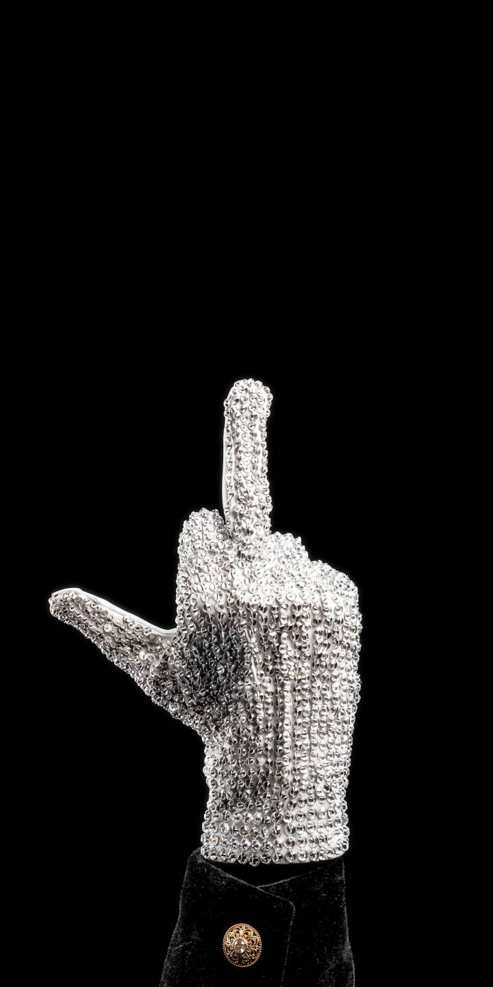Michael Jackson's dazzling, rhinestone-covered glove boldly raises a middle finger against a stark black background in this iconic 4K wallpaper, making an edgy statement for your iPhone and serving as a memorable mobile wallpaper. | iphone wallpaper mj mobile 4k wallpaper hd wallpaper edgy iconic middle finger michael jackson king of pop sparkling glove Michael Jackson's dazzling, rhinestone-covered glove boldly raises a middle finger against a stark black background in this iconic 4K wallpaper, making an edgy statement for your iPhone and serving as a memorable mobile wallpaper.