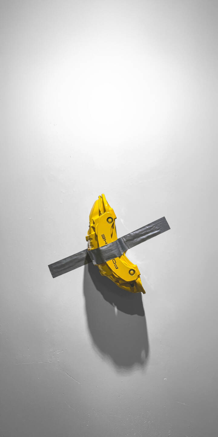 The vibrant yellow Porsche brake caliper, conspicuously taped with grey duct tape to a stark white wall, creates an arresting minimalist art piece in this stunning 4K wallpaper — a truly unique wallpaper for iPhone users seeking modern aesthetics. | yellow iphone porsche minimalist wallpaper mobile 4k wallpaper hd wallpaper automotive brake caliper modern art duct tape The vibrant yellow Porsche brake caliper, conspicuously taped with grey duct tape to a stark white wall, creates an arresting minimalist art piece in this stunning 4K wallpaper — a truly unique wallpaper for iPhone users seeking modern aesthetics.