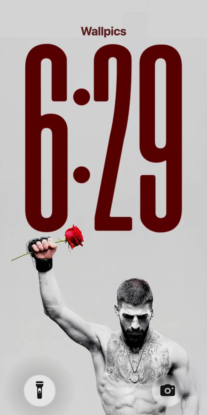 A vibrant red rose stands out in stark contrast against the grayscale aesthetic, clutched by a heavily tattooed man with a fierce gaze in this captivating 4K wallpaper for iPhone. This powerful image makes for a truly unique mobile wallpaper experience. | aesthetic man tattoo rose iphone minimalist wallpaper black and white mobile 4k wallpaper hd wallpaper red rose A vibrant red rose stands out in stark contrast against the grayscale aesthetic, clutched by a heavily tattooed man with a fierce gaze in this captivating 4K wallpaper for iPhone. This powerful image makes for a truly unique mobile wallpaper experience.