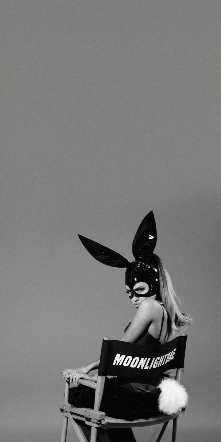 Ariana Grande's iconic black bunny mask and lustrous long hair define this striking 4K wallpaper, as she sits elegantly on a 'MOONLIGHTBAE' director's chair. This monochrome wallpaper, complete with a fluffy white bunny tail, is a captivating choice for any iPhone background. | aesthetic iphone wallpaper mobile ariana grande celebrity 4k wallpaper hd wallpaper monochrome ariana bunny mask moonlightbae Ariana Grande's iconic black bunny mask and lustrous long hair define this striking 4K wallpaper, as she sits elegantly on a 'MOONLIGHTBAE' director's chair. This monochrome wallpaper, complete with a fluffy white bunny tail, is a captivating choice for any iPhone background.