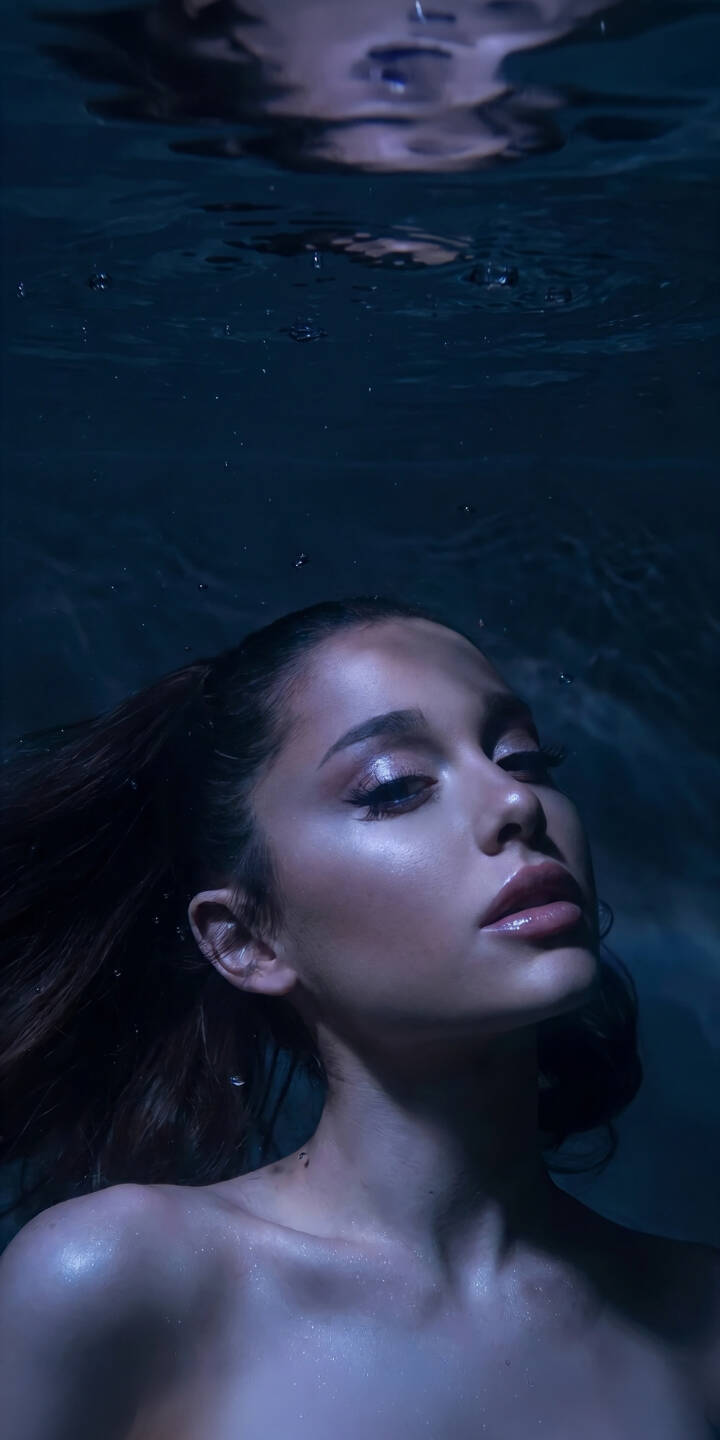 A soft glow highlights Ariana Grande's glistening skin in this captivating 4K underwater wallpaper, creating an ethereal mood that is perfect for your iPhone. This beautiful wallpaper features subtle reflections on the water's surface. | underwater singer iphone wallpaper mobile ariana grande celebrity 4k wallpaper hd wallpaper dark aesthetic ariana ethereal A soft glow highlights Ariana Grande's glistening skin in this captivating 4K underwater wallpaper, creating an ethereal mood that is perfect for your iPhone. This beautiful wallpaper features subtle reflections on the water's surface.