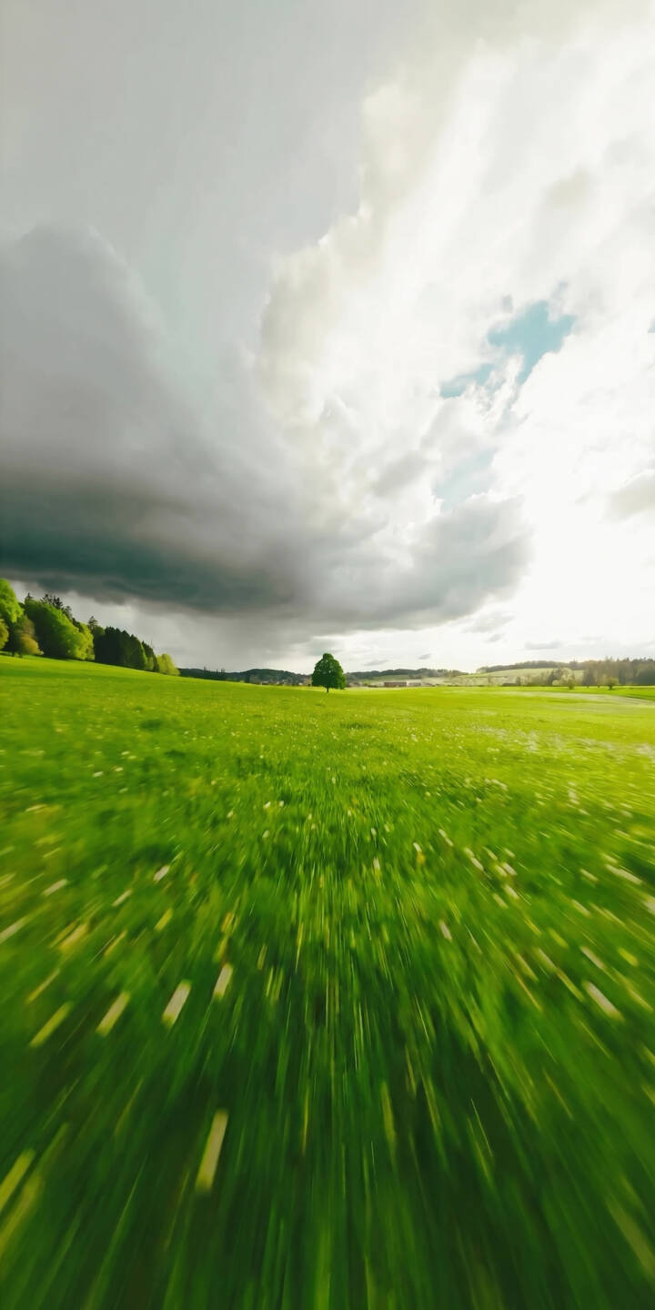 Dark stormy clouds loom over a vibrant green field in this stunning 4K wallpaper, capturing a serene single tree under a dynamic sky. It's an ideal wallpaper for iPhone users seeking a blend of nature and dramatic weather. | landscape iphone nature wallpaper mobile green field 4k wallpaper hd wallpaper lone tree stormy sky scenic motion blur Dark stormy clouds loom over a vibrant green field in this stunning 4K wallpaper, capturing a serene single tree under a dynamic sky. It's an ideal wallpaper for iPhone users seeking a blend of nature and dramatic weather.