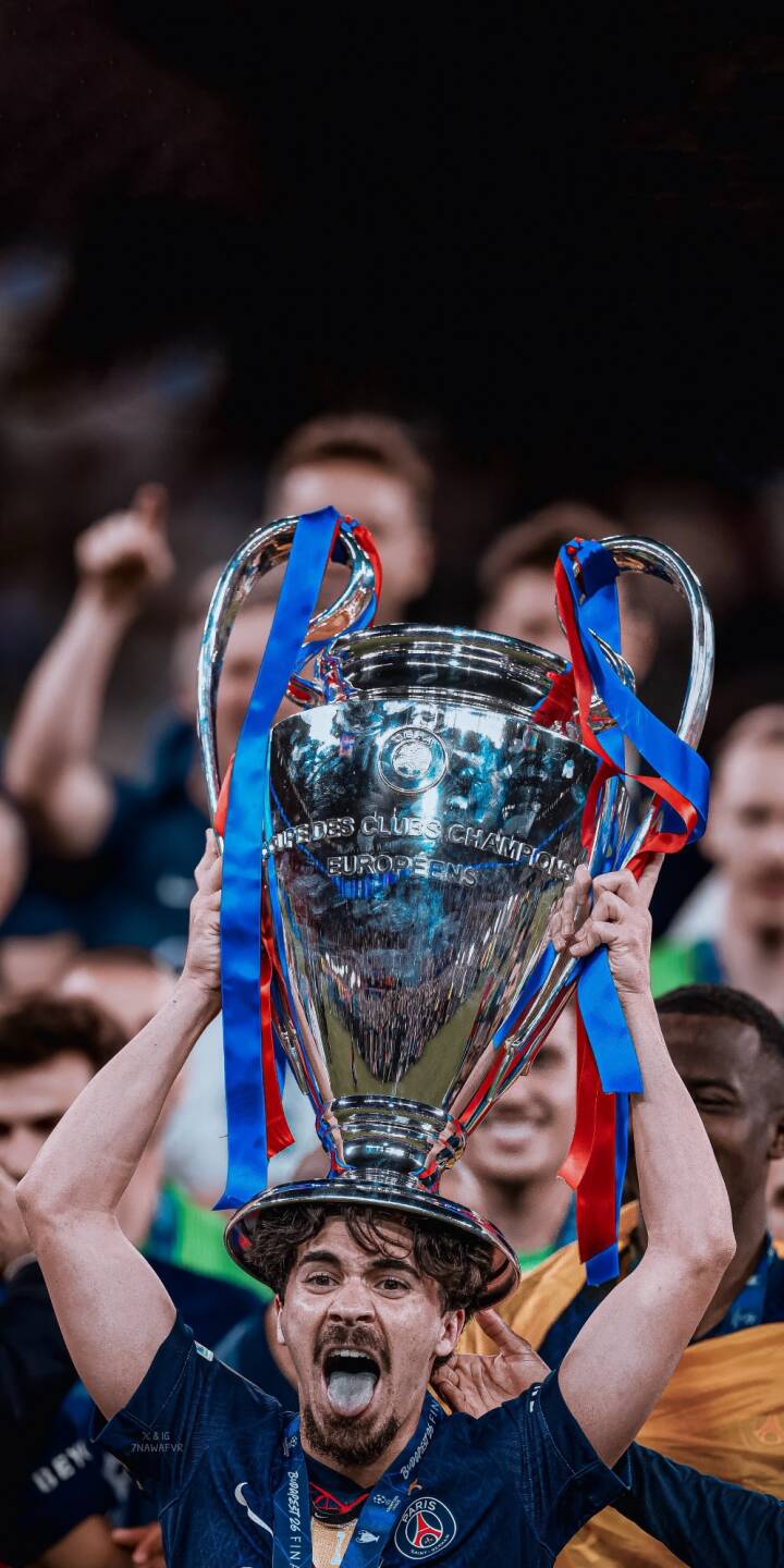 The jubilant footballer hoists the gleaming Champions League trophy overhead, his mouth open and tongue out in pure celebration in this stunning 4K wallpaper. This vibrant moment is a perfect wallpaper for iPhone, capturing the thrill of victory. | sports football trophy celebration iphone soccer wallpaper mobile 4k wallpaper hd wallpaper champions league victory The jubilant footballer hoists the gleaming Champions League trophy overhead, his mouth open and tongue out in pure celebration in this stunning 4K wallpaper. This vibrant moment is a perfect wallpaper for iPhone, capturing the thrill of victory.