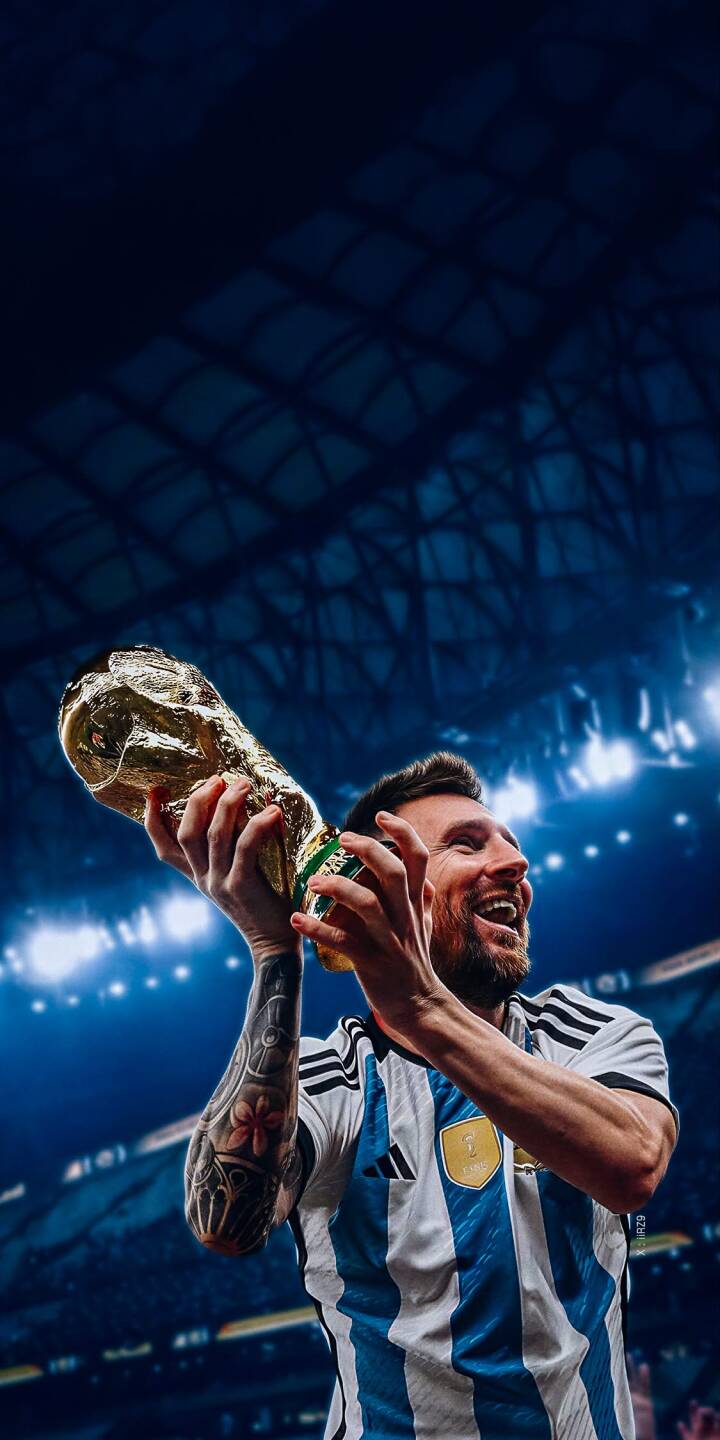 The golden World Cup trophy gleams as a jubilant Lionel Messi hoists it high with an ecstatic smile, illuminated by stadium lights in this iconic 4K wallpaper. This celebratory wallpaper for iPhone perfectly captures his triumphant moment in the blue and white Argentina jersey. | sports football celebration iphone messi argentina wallpaper lionel messi mobile 4k wallpaper hd wallpaper world cup The golden World Cup trophy gleams as a jubilant Lionel Messi hoists it high with an ecstatic smile, illuminated by stadium lights in this iconic 4K wallpaper. This celebratory wallpaper for iPhone perfectly captures his triumphant moment in the blue and white Argentina jersey.