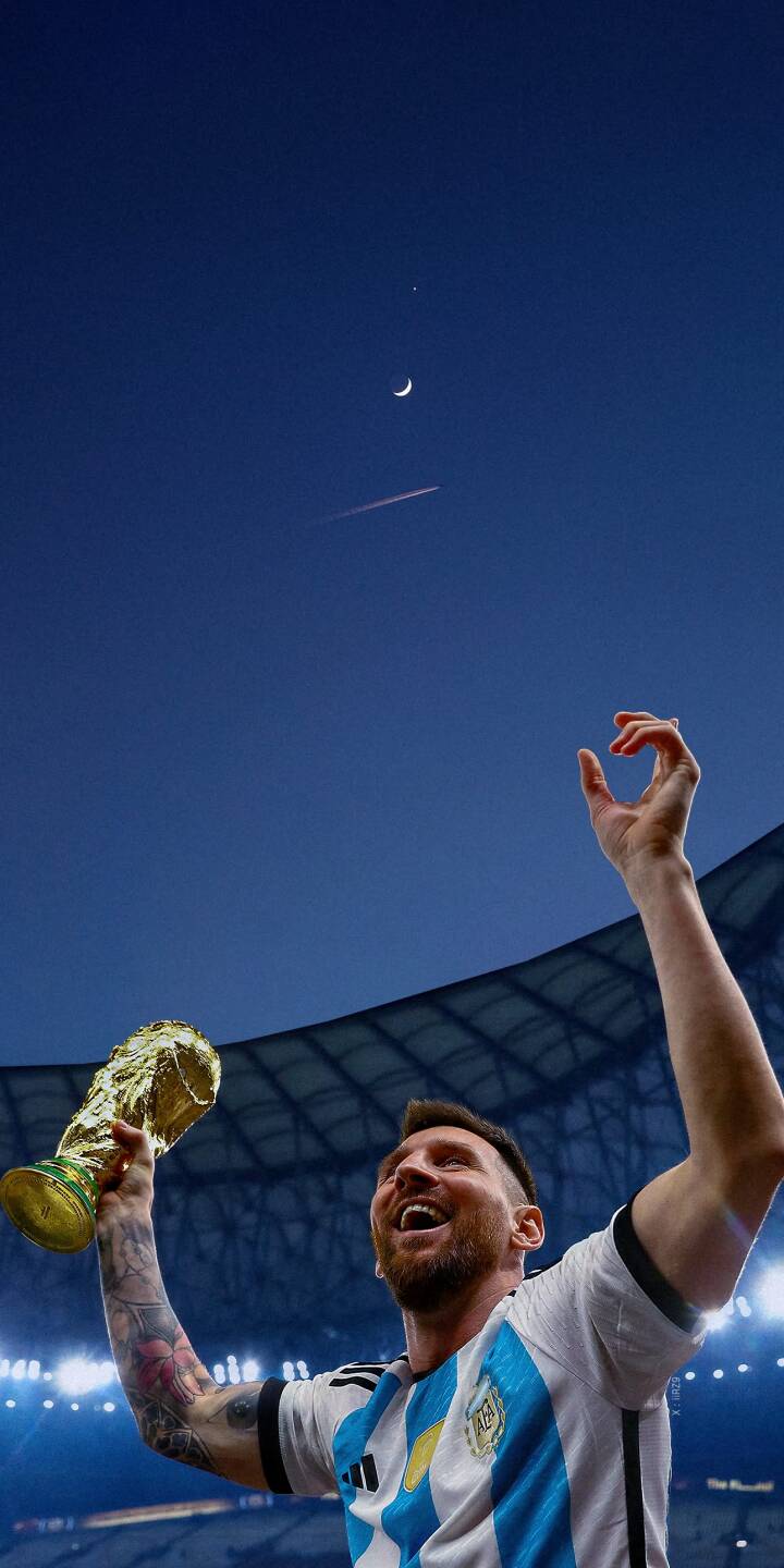 Radiant with joy, Lionel Messi proudly lifts the golden World Cup trophy into a deep blue evening sky with a visible crescent moon. This iconic 4K wallpaper, featuring the ecstatic football legend, is a must-have wallpaper for your iPhone. | football trophy celebration iphone messi argentina wallpaper lionel messi mobile 4k wallpaper hd wallpaper world cup Radiant with joy, Lionel Messi proudly lifts the golden World Cup trophy into a deep blue evening sky with a visible crescent moon. This iconic 4K wallpaper, featuring the ecstatic football legend, is a must-have wallpaper for your iPhone.