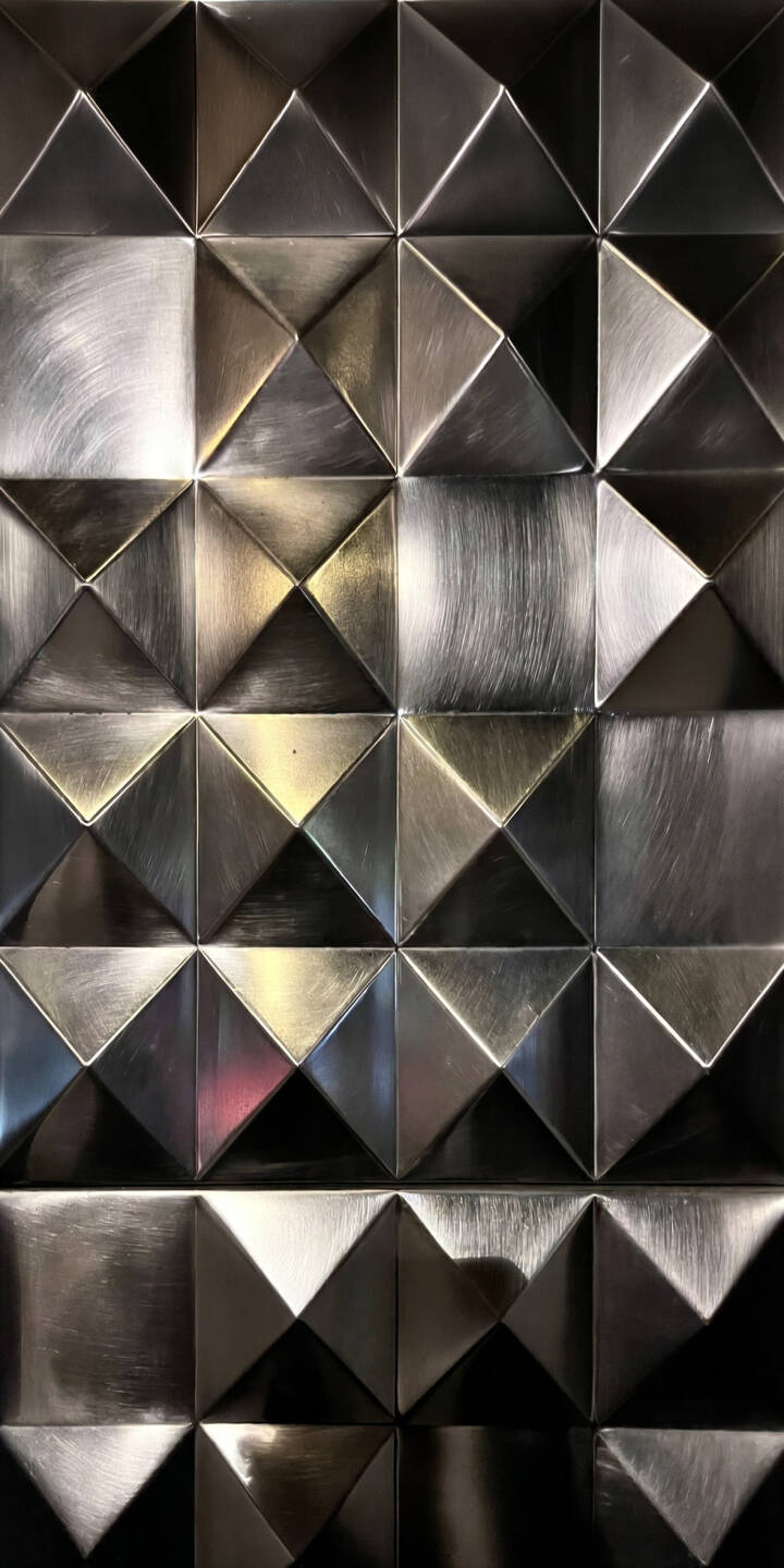Intertwining brushed metallic squares and triangular facets catch the light, creating a dynamic interplay of silver and shadow in this stunning 4K wallpaper. This textured geometric wallpaper offers a sophisticated and modern backdrop for your iPhone. | silver iphone abstract wallpaper modern texture mobile metallic 4k wallpaper hd wallpaper geometric industrial Intertwining brushed metallic squares and triangular facets catch the light, creating a dynamic interplay of silver and shadow in this stunning 4K wallpaper. This textured geometric wallpaper offers a sophisticated and modern backdrop for your iPhone.