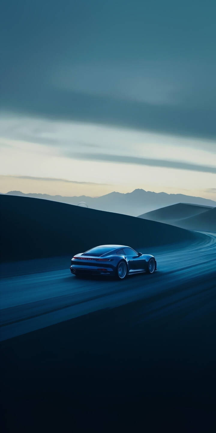 A dark blue, sleek sports car navigates a winding road through desolate, dark blue dunes under a muted sky in this stunning 4K wallpaper — an atmospheric wallpaper perfect for iPhone. | aesthetic blue landscape car sports car desert iphone minimalist wallpaper mobile 4k wallpaper hd wallpaper A dark blue, sleek sports car navigates a winding road through desolate, dark blue dunes under a muted sky in this stunning 4K wallpaper — an atmospheric wallpaper perfect for iPhone.