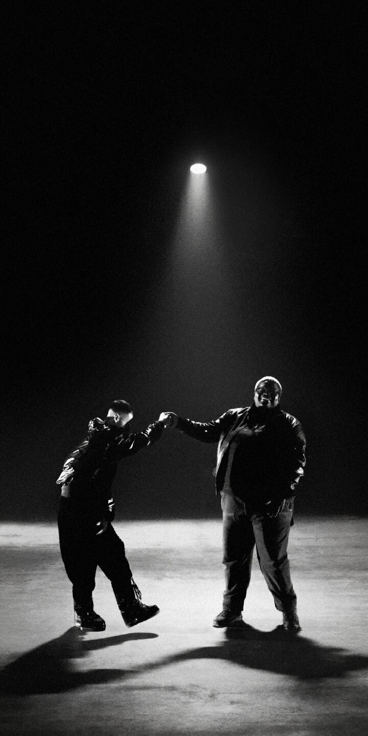 A single, piercing spotlight illuminates two figures on a stark concrete floor, creating deep shadows in this monochromatic 4K wallpaper. This powerful and minimalist scene makes a striking iPhone wallpaper. | duo dark iphone minimalist wallpaper black and white spotlight men mobile 4k wallpaper hd wallpaper monochrome A single, piercing spotlight illuminates two figures on a stark concrete floor, creating deep shadows in this monochromatic 4K wallpaper. This powerful and minimalist scene makes a striking iPhone wallpaper.