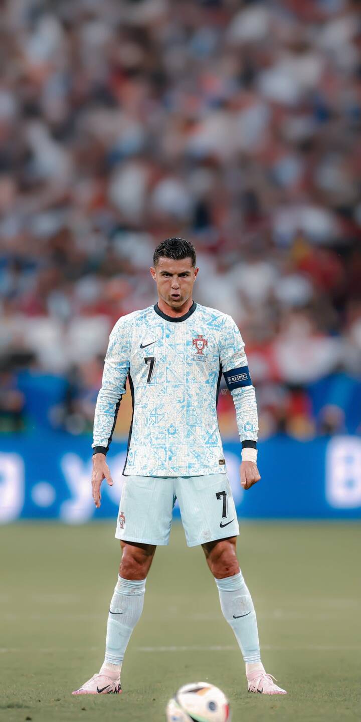 Cristiano Ronaldo's intense gaze dominates this stunning 4K wallpaper, featuring him in his distinctive light blue Portugal kit on the pitch with the ball at his feet. This dynamic wallpaper is perfect for your iPhone, showcasing the iconic football legend. | football athlete iphone ronaldo soccer wallpaper cr7 portugal cristiano ronaldo mobile 4k wallpaper hd wallpaper Cristiano Ronaldo's intense gaze dominates this stunning 4K wallpaper, featuring him in his distinctive light blue Portugal kit on the pitch with the ball at his feet. This dynamic wallpaper is perfect for your iPhone, showcasing the iconic football legend.