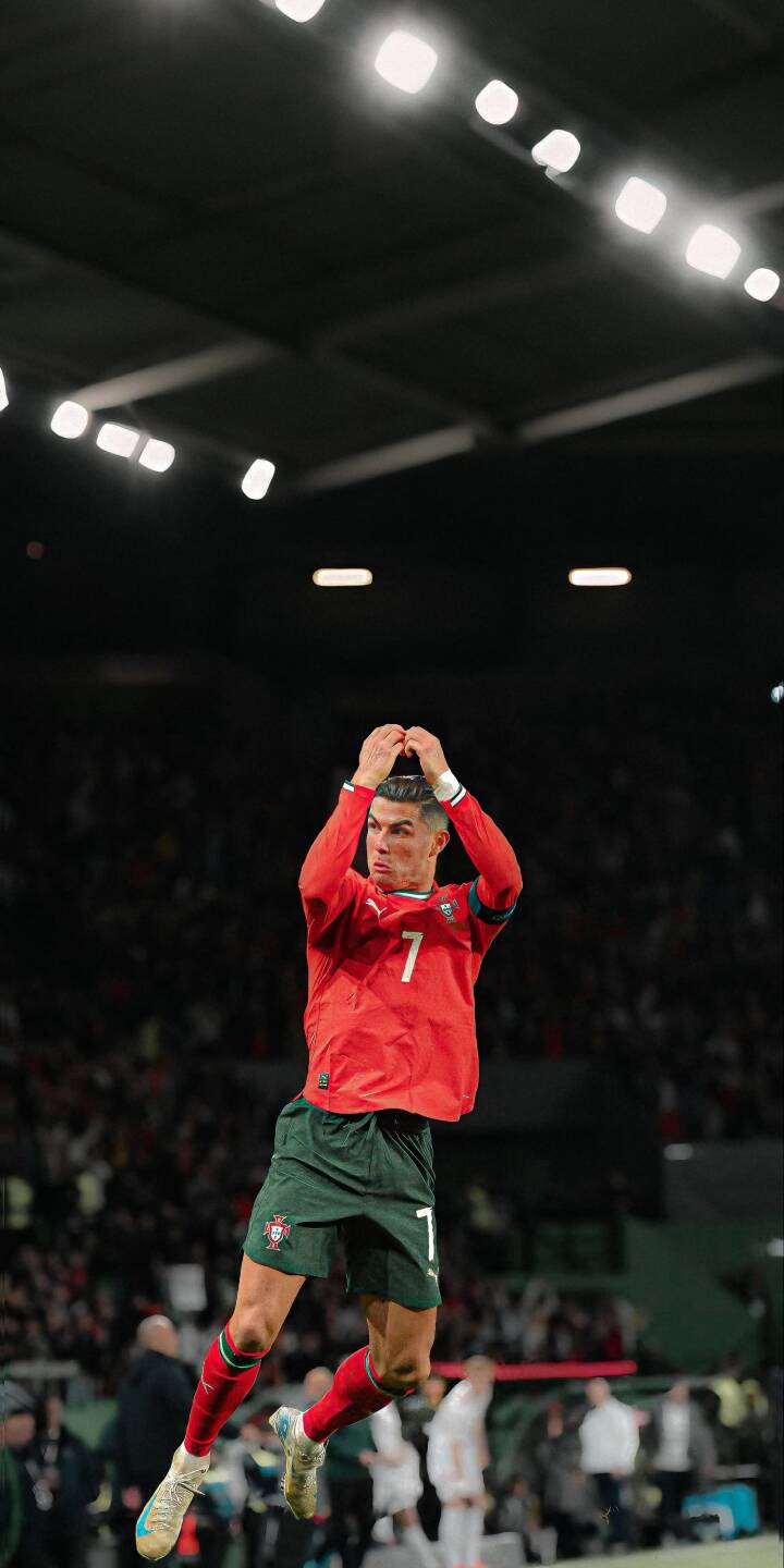 Cristiano Ronaldo leaps high in a jubilant celebration, hands clasped above his head in this dynamic 4K wallpaper, perfect for iPhone screens. His iconic Portugal kit gleams under the bright stadium lights, making this an energetic mobile wallpaper. | stadium celebration iphone ronaldo soccer wallpaper cr7 portugal cristiano ronaldo mobile 4k wallpaper hd wallpaper Cristiano Ronaldo leaps high in a jubilant celebration, hands clasped above his head in this dynamic 4K wallpaper, perfect for iPhone screens. His iconic Portugal kit gleams under the bright stadium lights, making this an energetic mobile wallpaper.