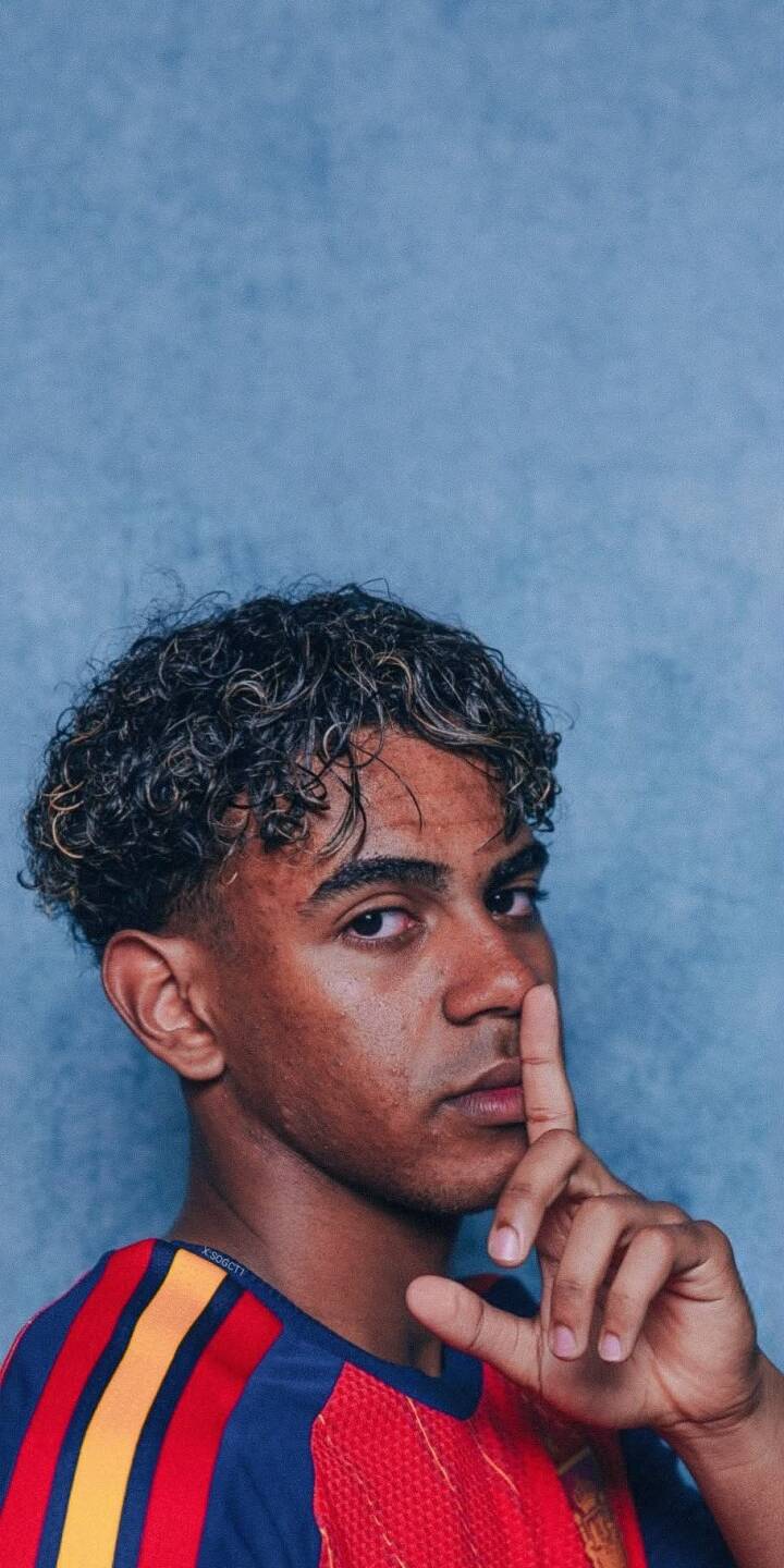 The subtle shushing gesture immediately draws attention in this captivating 4K wallpaper featuring a young man with distinct highlighted curly hair. His colorful striped top pops against the calm blue background, making this an engaging iPhone wallpaper. | aesthetic portrait iphone wallpaper quiet mobile 4k wallpaper hd wallpaper curly hair blue background shhh young man The subtle shushing gesture immediately draws attention in this captivating 4K wallpaper featuring a young man with distinct highlighted curly hair. His colorful striped top pops against the calm blue background, making this an engaging iPhone wallpaper.