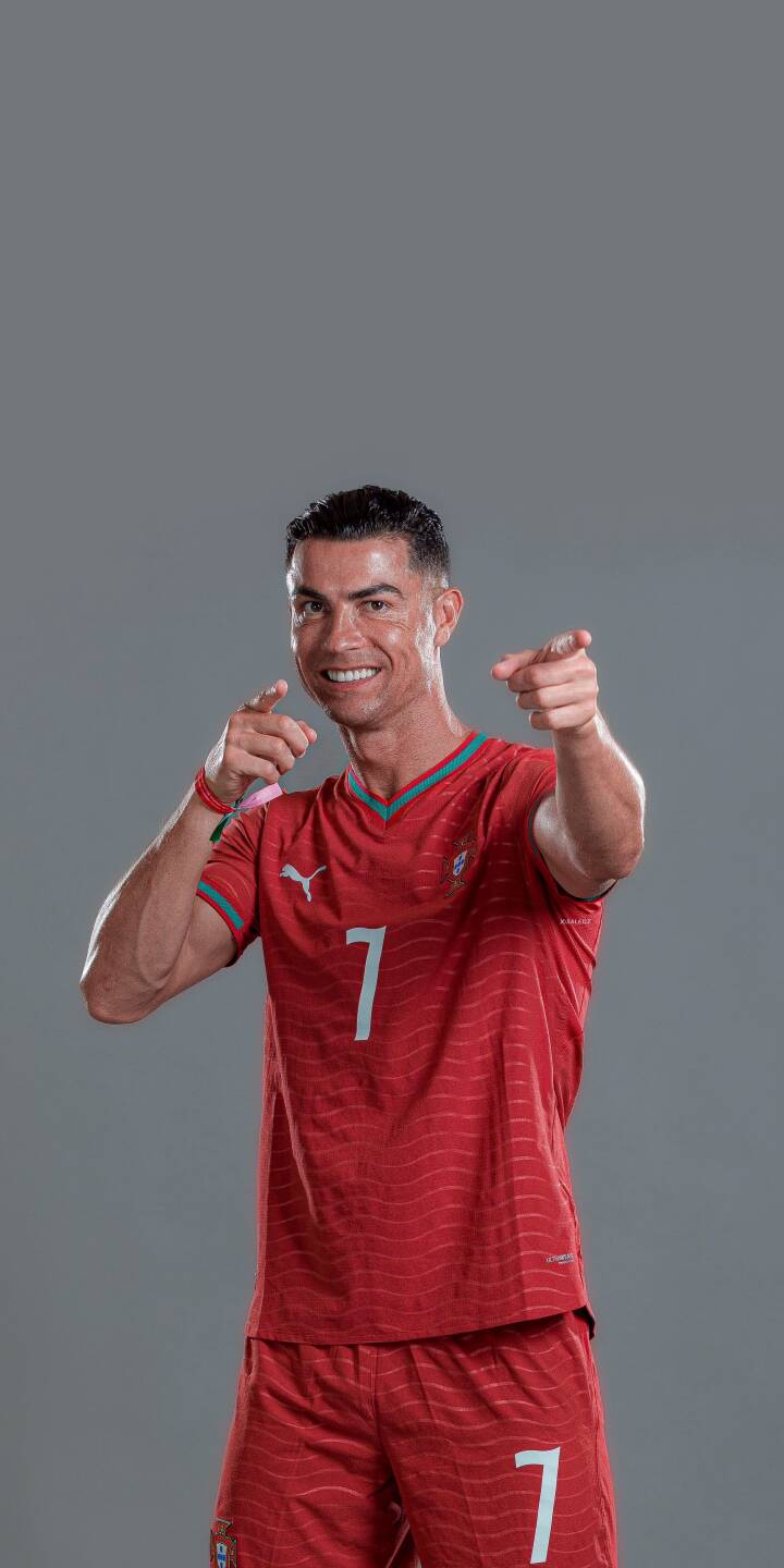 Cristiano Ronaldo's confident smile and dual pointing gesture dominate this engaging 4K wallpaper, featuring him in his iconic red number 7 kit – an essential wallpaper for iPhone fans. This vibrant image captures the football legend's dynamic personality. | football iphone ronaldo soccer wallpaper cr7 cristiano ronaldo mobile 4k wallpaper hd wallpaper pointing red kit Cristiano Ronaldo's confident smile and dual pointing gesture dominate this engaging 4K wallpaper, featuring him in his iconic red number 7 kit – an essential wallpaper for iPhone fans. This vibrant image captures the football legend's dynamic personality.