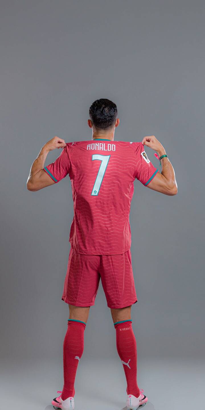 Cristiano Ronaldo reveals his iconic red number 7 jersey from behind, set against a sleek grey backdrop in this vibrant 4K wallpaper. This stunning football legend wallpaper is a must-have for your iPhone. | sports football iphone ronaldo soccer wallpaper cr7 cristiano ronaldo jersey mobile 4k wallpaper hd wallpaper Cristiano Ronaldo reveals his iconic red number 7 jersey from behind, set against a sleek grey backdrop in this vibrant 4K wallpaper. This stunning football legend wallpaper is a must-have for your iPhone.