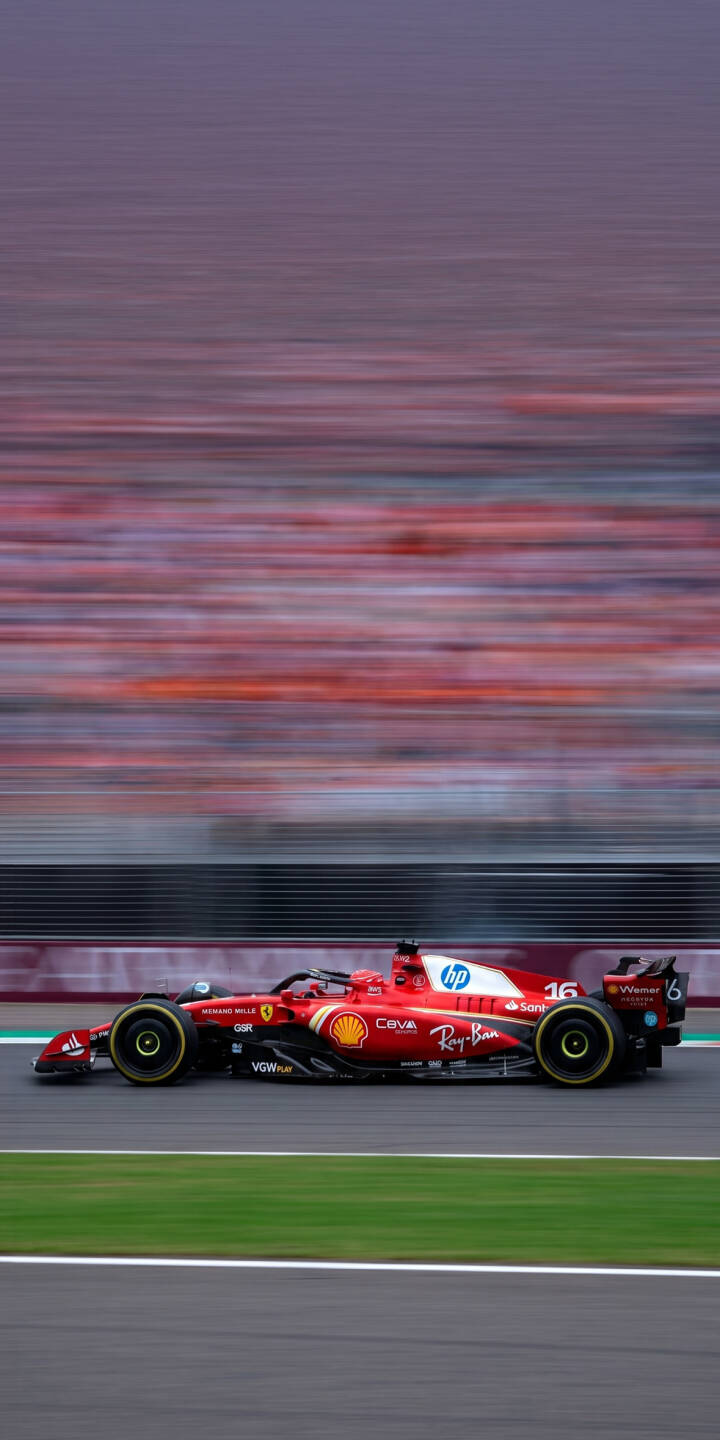 The iconic red Ferrari F1 car, number 16, blazes across the track with dynamic speed, its yellow-accented wheels blurring against a vivid backdrop of stadium lights. This stunning 4K wallpaper offers an exhilarating view for any racing fan, making it a perfect iPhone wallpaper for adrenaline junkies. | track iphone ferrari wallpaper f1 racing speed formula 1 mobile red car 4k wallpaper hd wallpaper The iconic red Ferrari F1 car, number 16, blazes across the track with dynamic speed, its yellow-accented wheels blurring against a vivid backdrop of stadium lights. This stunning 4K wallpaper offers an exhilarating view for any racing fan, making it a perfect iPhone wallpaper for adrenaline junkies.